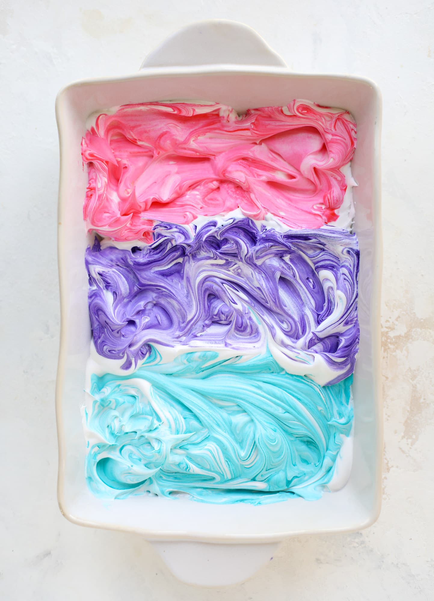 This is how to dye eggs with cool whip! It's so fun, super kid-friendly and ridiculously easy too. I love using this method to make unicorn eggs!