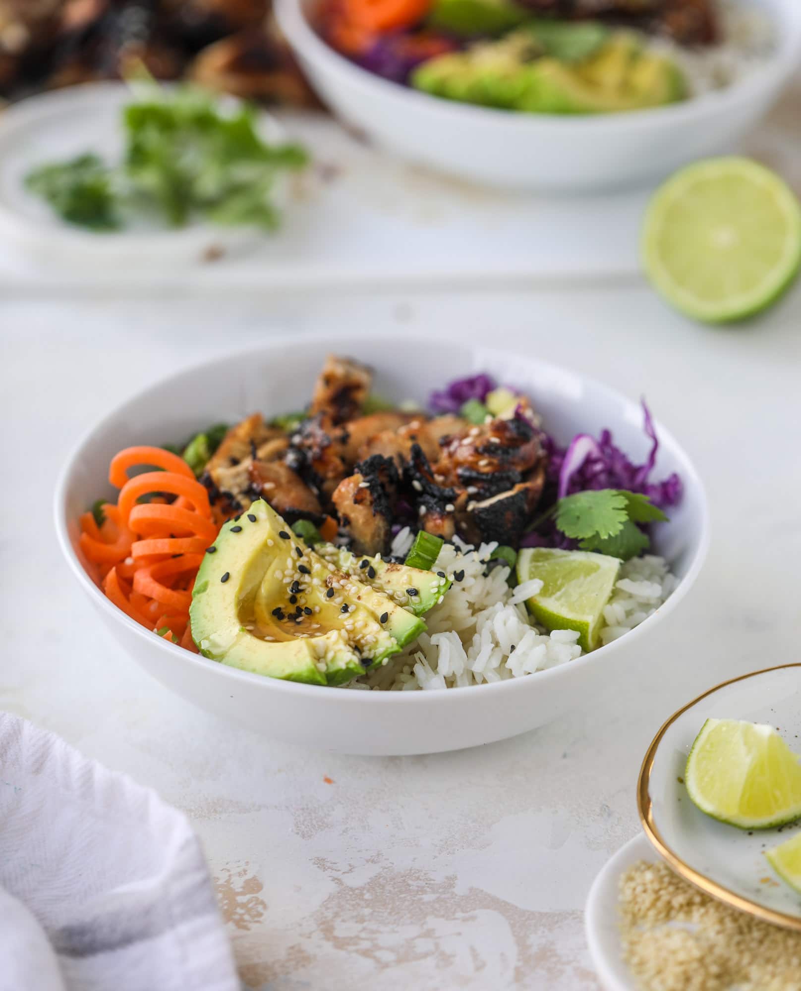 Korean chicken bowls are loaded with flavor: toasted sesame, soy sauce and lime come together over coconut rice and avocado to create a delicious meal! I howsweeteats.com #korean #chicken