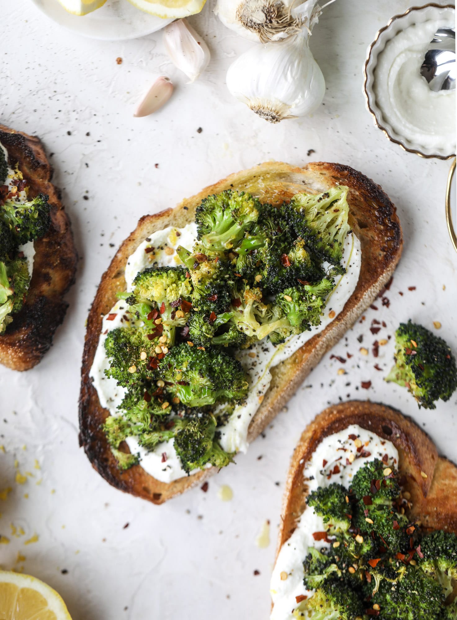 Broccoli toast is the best way to sneak in some veggies! Toasted sourdough with ricotta and roasted broccoli, topped with lemon and crushed red pepper. 