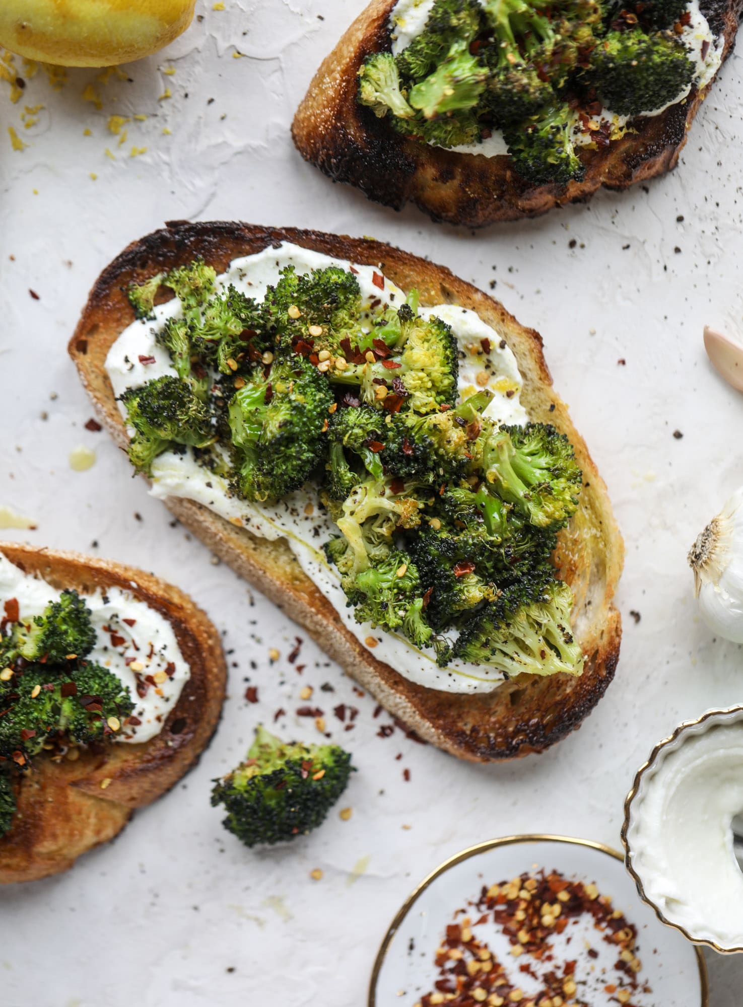 Broccoli toast is the best way to sneak in some veggies! Toasted sourdough with ricotta and roasted broccoli, topped with lemon and crushed red pepper. 