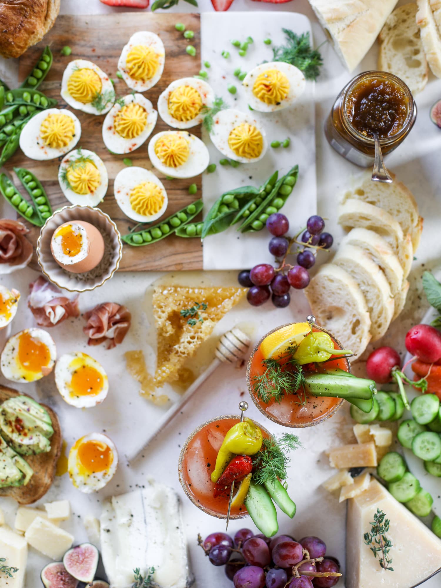 The highlight of this Easter brunch board are the deviled eggs and soft boiled eggs! Add some avocado toast, donuts and bloody marys and you've arrived. I howsweeteats.com #brunch #board