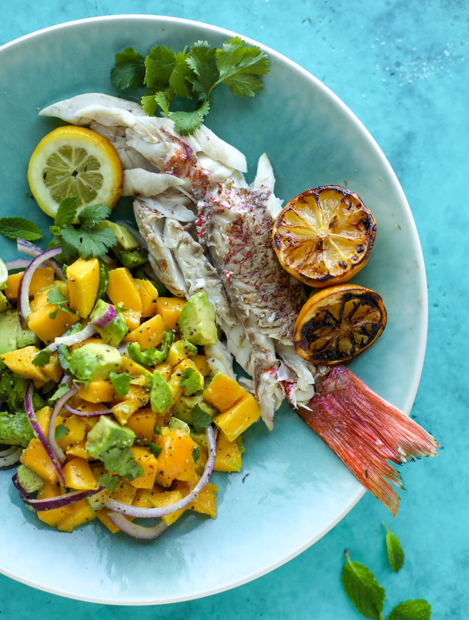 Grilled whole fish is easier than it looks! Try this recipe for the butteriest, most flavorful grilled snapper paired with an avocado mango salad.