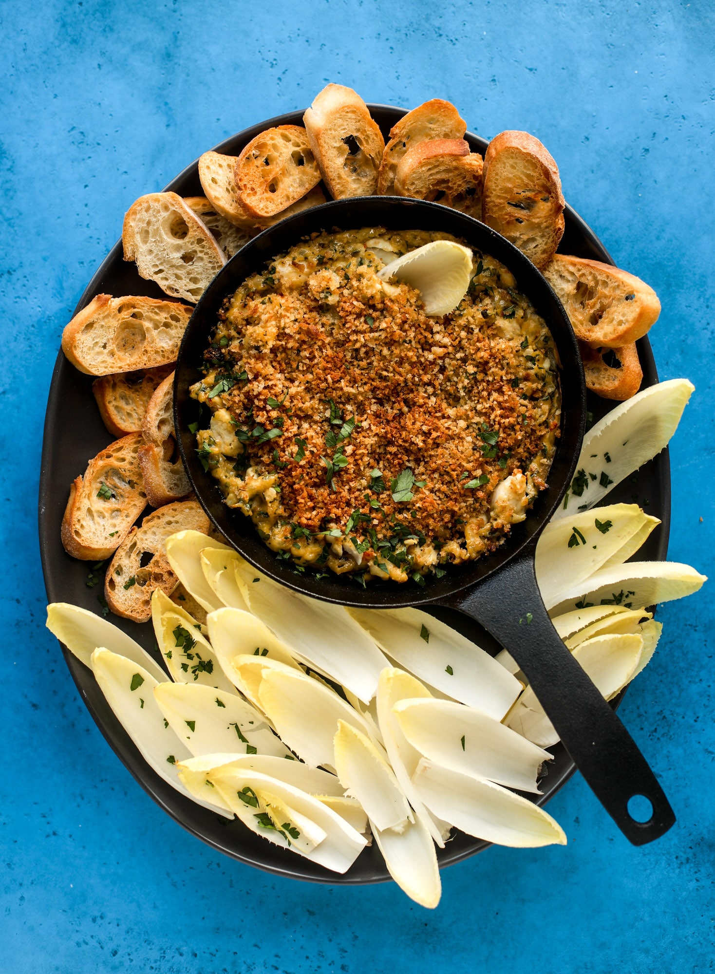 This deviled crab dip is the perfect hot summer appetizer. Lump crab, a creamy, decadent sauce, crunchy breadcrumbs and fresh endive for dipping. YES.