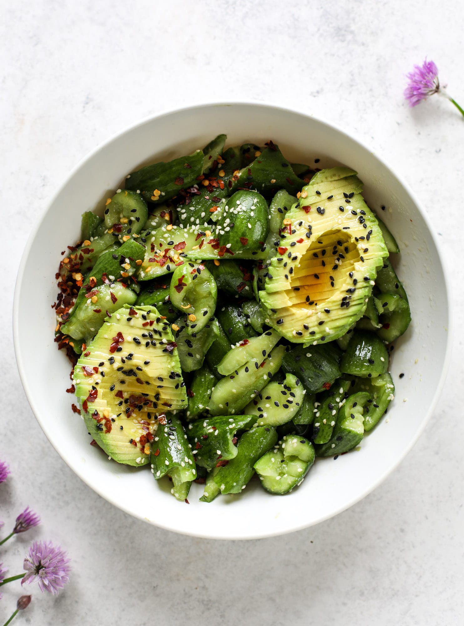 This smashed cucumber salad is so refreshing and perfect for summer! Served with avocado, toasted sesame oil and chives, it's ridiculously flavorful.