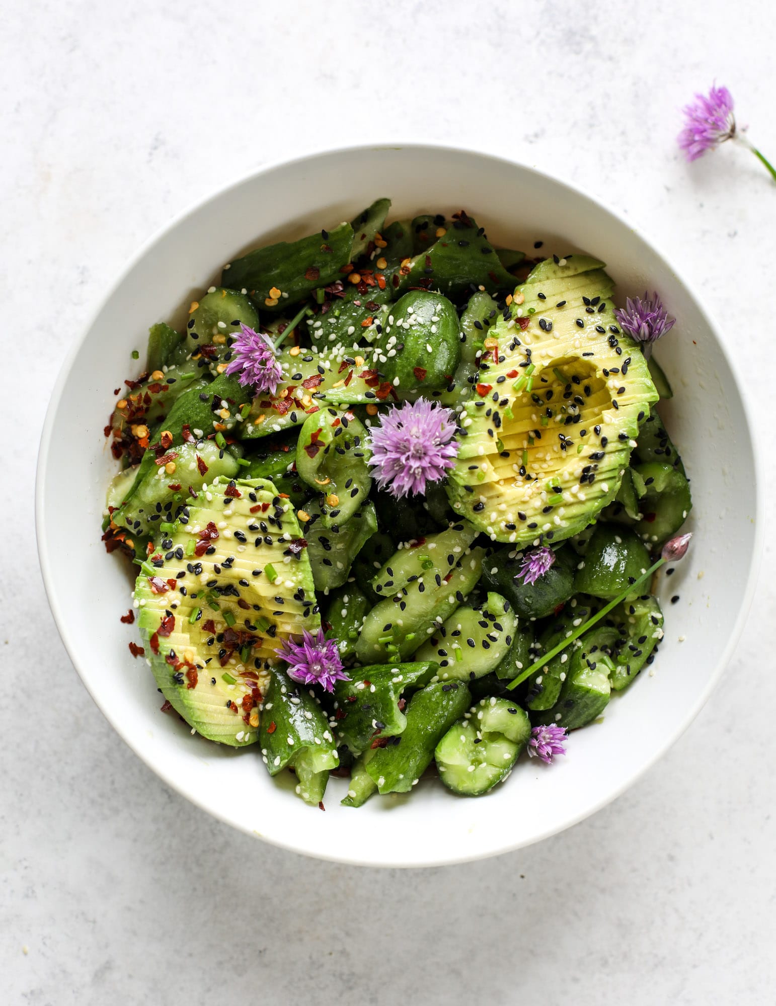 This smashed cucumber salad is so refreshing and perfect for summer! Served with avocado, toasted sesame oil and chives, it's ridiculously flavorful.