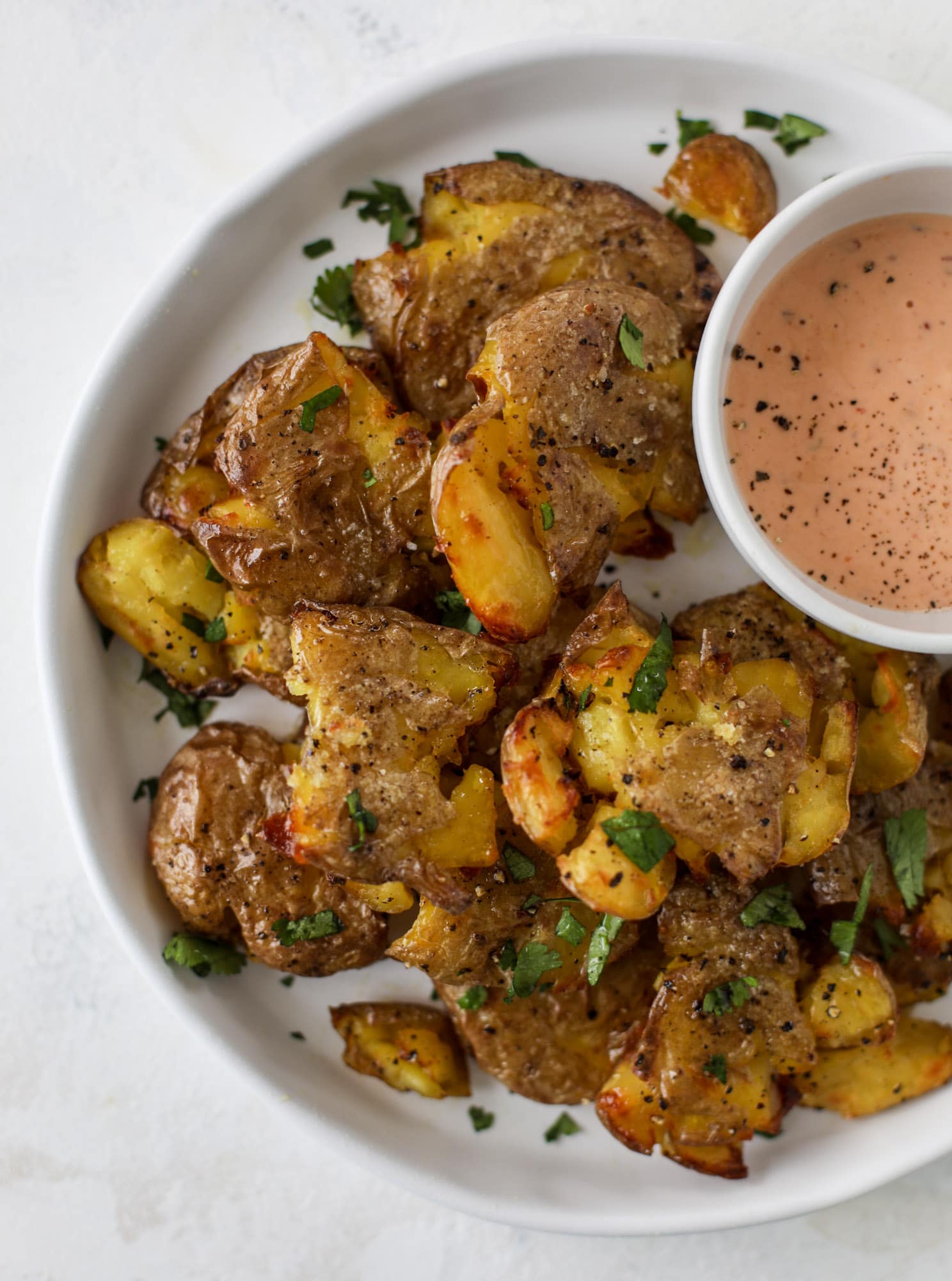 This is our favorite side dish ever! Crispy smashed potatoes roasted in the oven to perfection. Serve them with a dipping sauce or as a side dish!