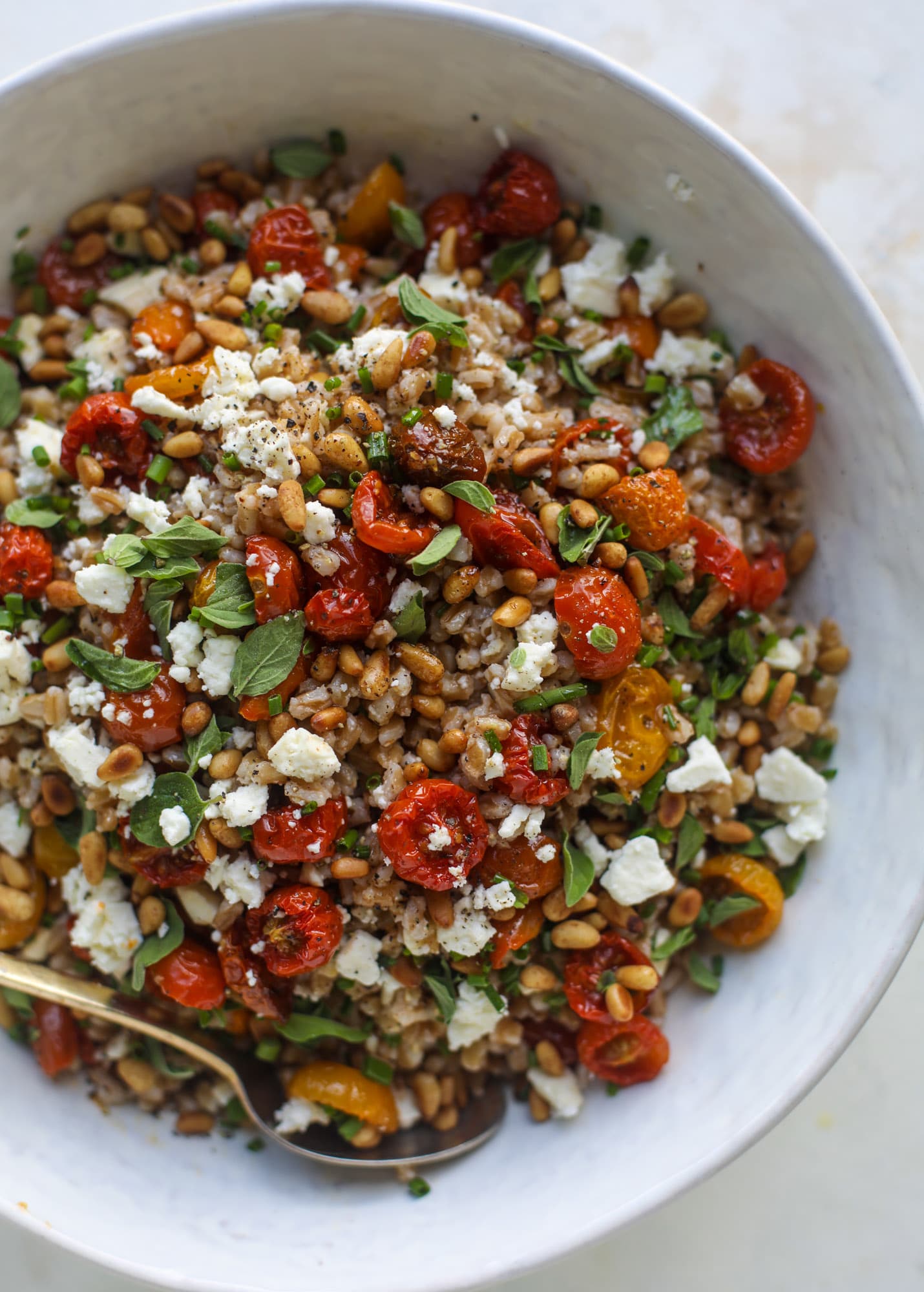 A tomato farro salad that is sweet from the slow roasted tomatoes, tangy from the feta cheese, chewy from the farro and bright from the lemon!
