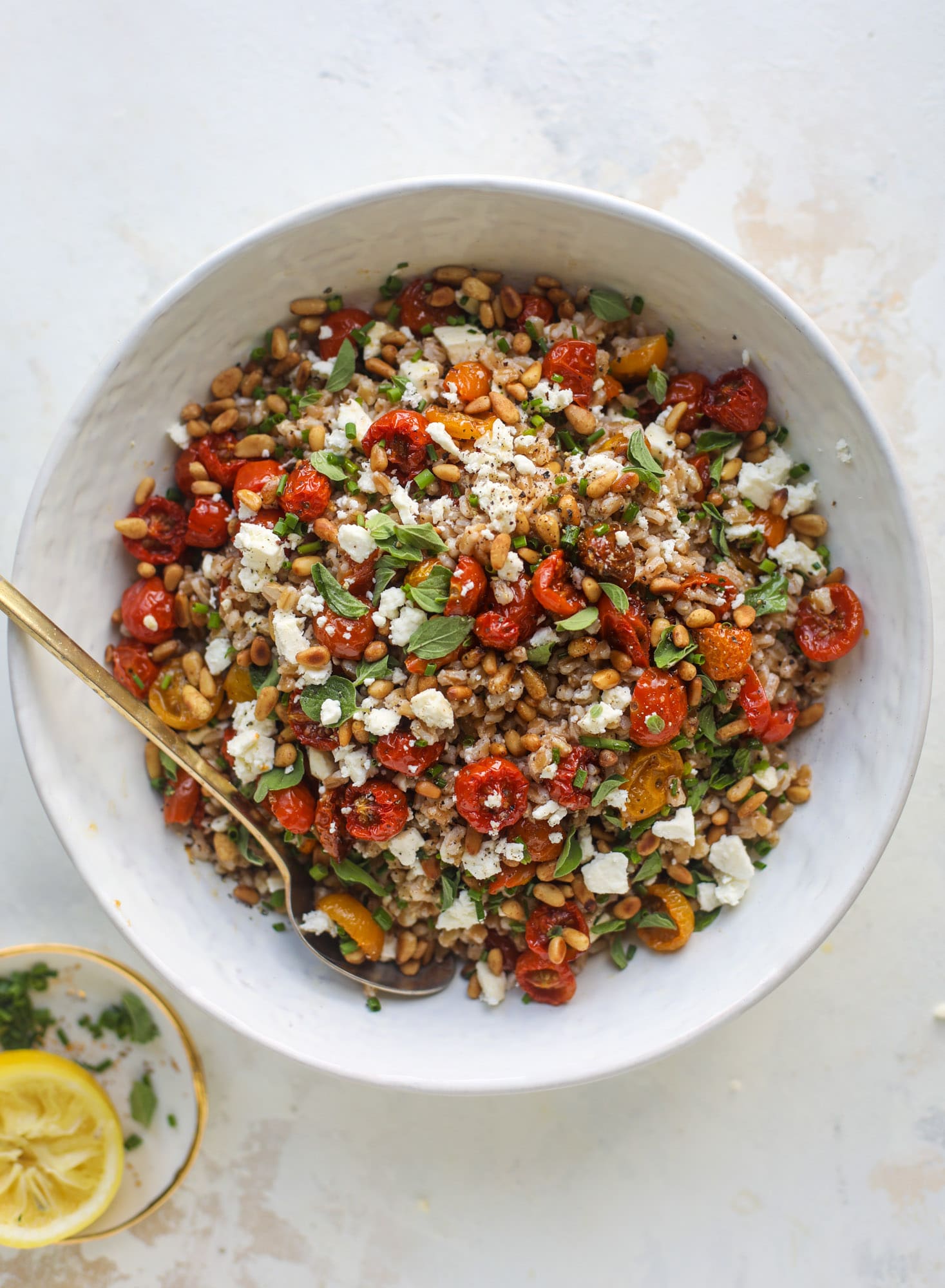 A tomato farro salad that is sweet from the slow roasted tomatoes, tangy from the feta cheese, chewy from the farro and bright from the lemon!