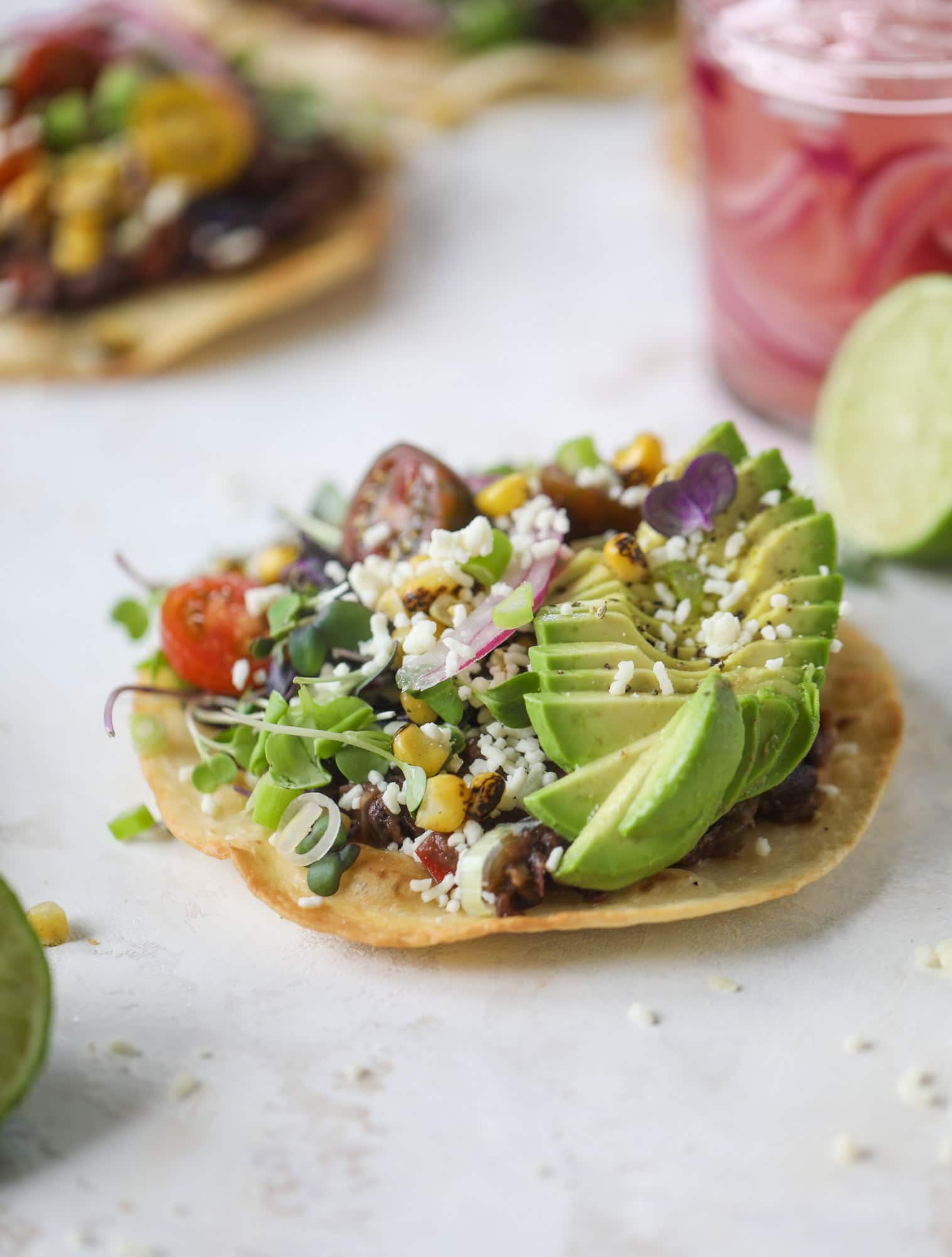 These saucy black bean tostadas are super flavorful and easy for a weeknight meal. Crunchy tortillas topped with beans and tons of veggies. Delish!
