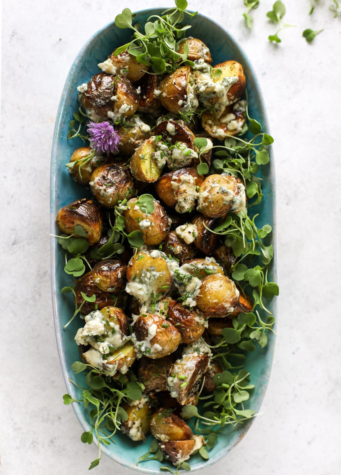 These grilled gorgonzola potatoes are loaded with flavor! Crispy, crunchy grilled bab golds topped with creamy blue cheese and fresh herbs.