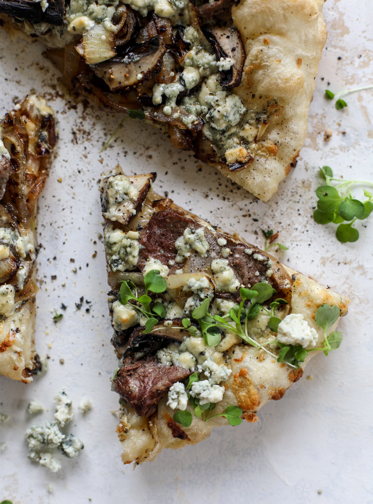 This grilled steakhouse pizza has all the amazing smoky flavors of your favorite steakhouse. Grilled onions, mushrooms and creamy gorgonzola finish it off.