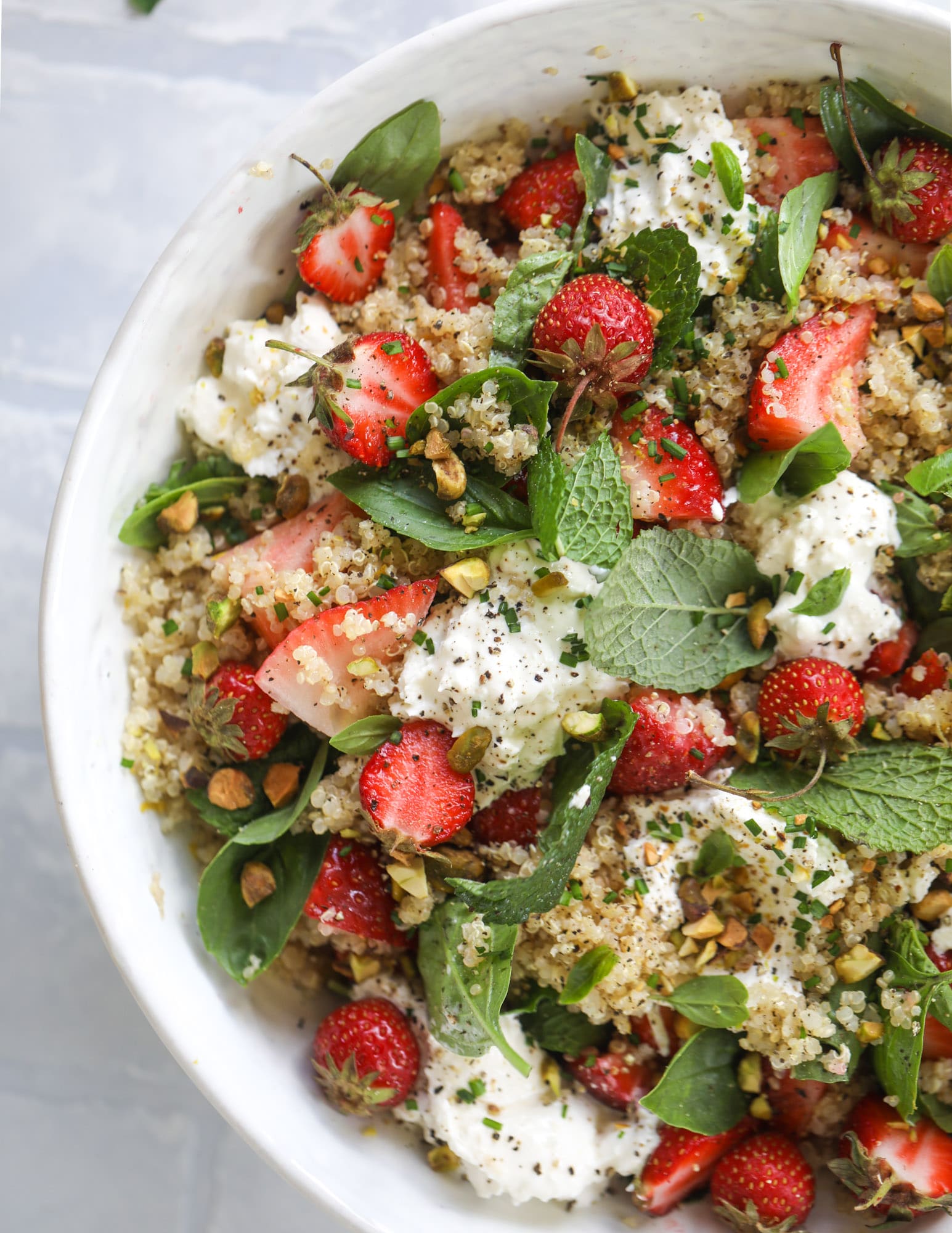 This strawberry quinoa salad is loaded with fresh herbs, burrata cheese and chopped pistachios. Topped with a lemon dressing, it's heavenly! 