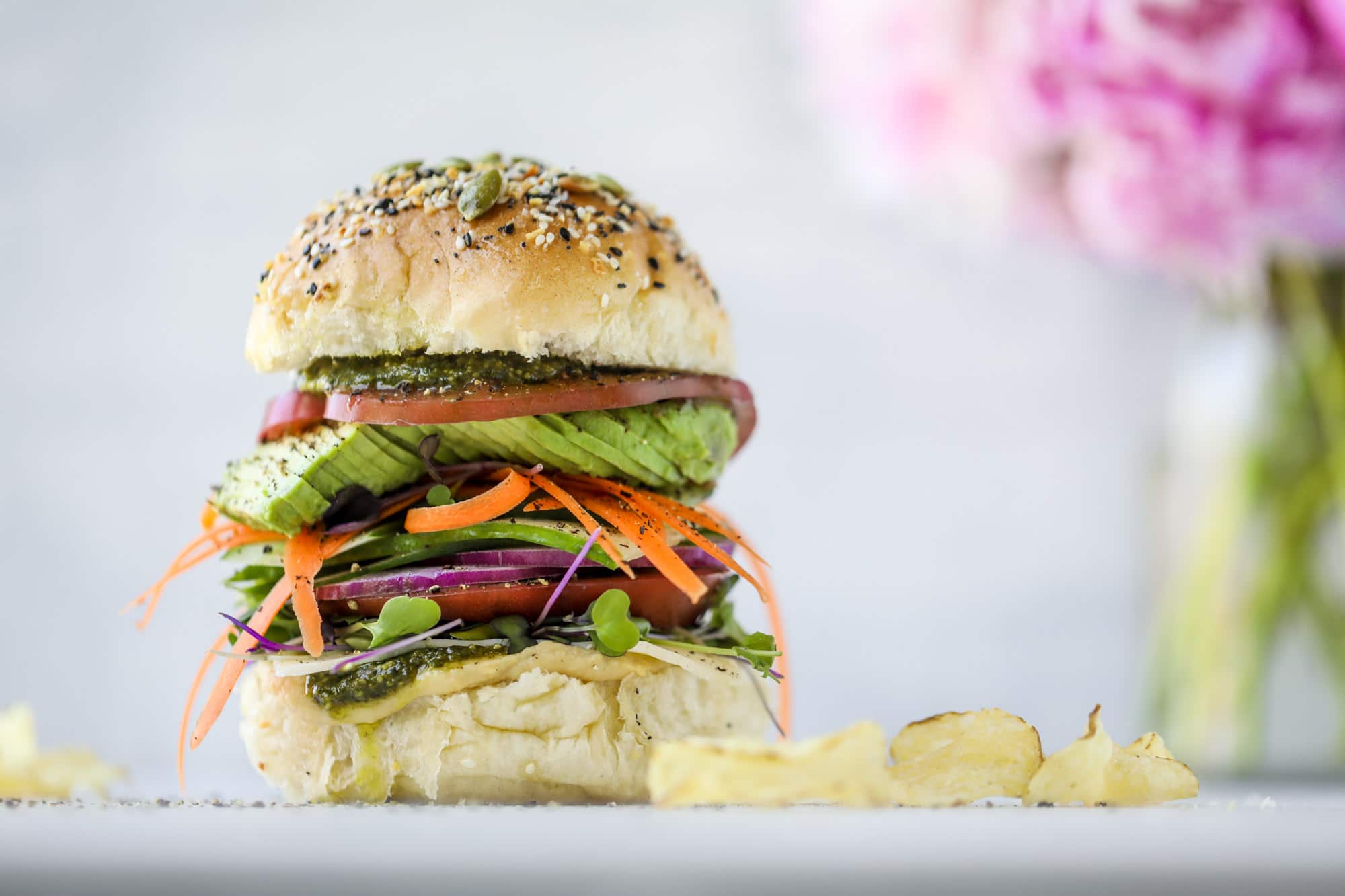 This summer veggie sandwich is full of creamy hummus, fresh pesto and havarti cheese along with tons of sliced, fresh vegetables. Best lunch ever!
