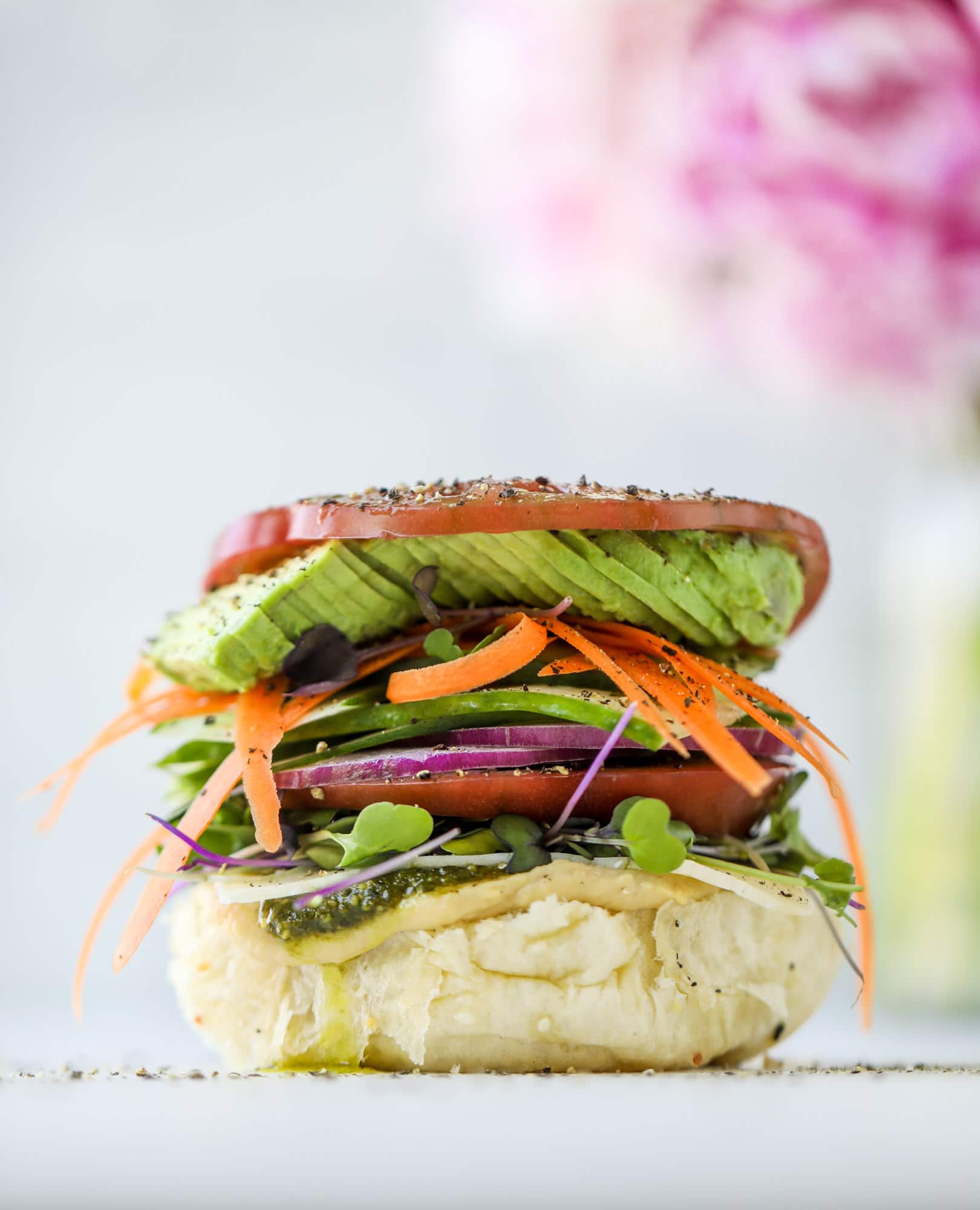 This summer veggie sandwich is full of creamy hummus, fresh pesto and havarti cheese along with tons of sliced, fresh vegetables. Best lunch ever!
