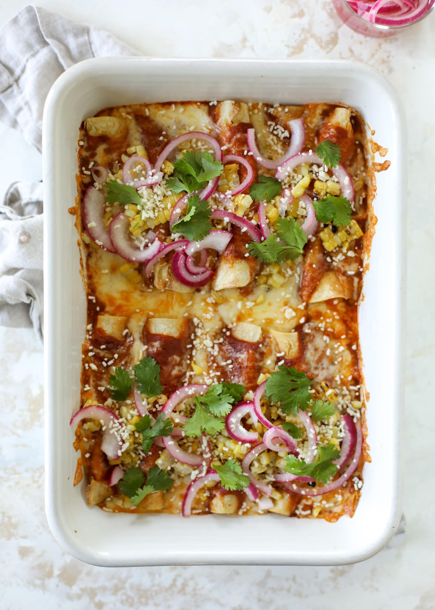 These grilled corn enchiladas are the perfect summer meal! Grilled corn, zucchini, homemade sauce and cheese come together for a flavor explosion!
