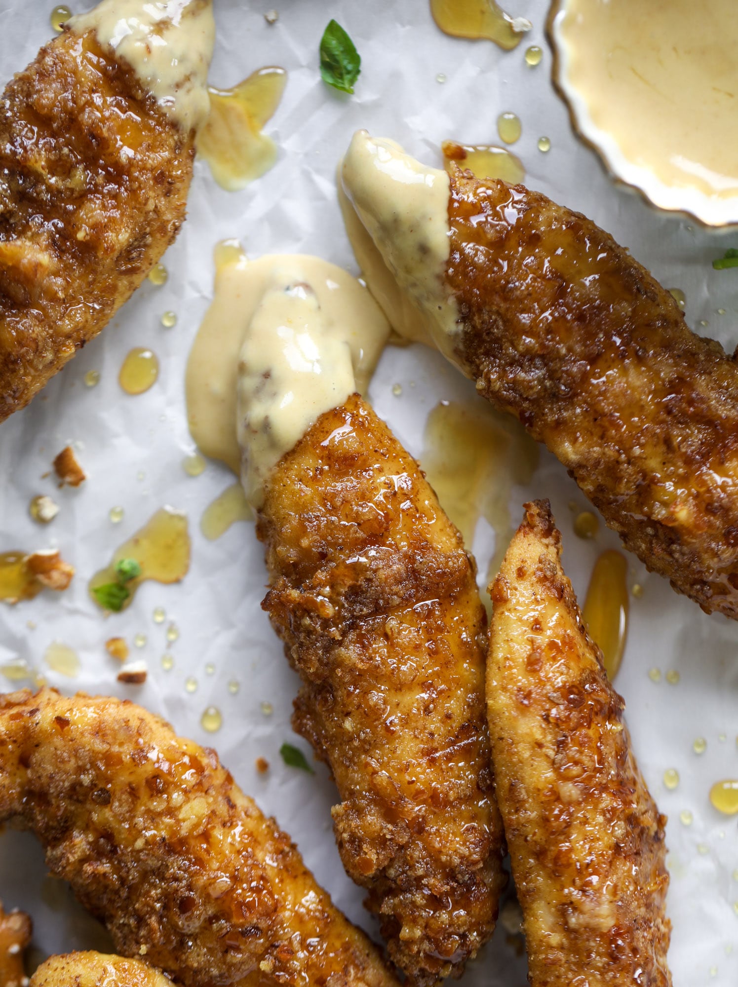 These pretzel crusted chicken fingers are baked, crunchy and ridiculously flavorful. Drizzle with hot honey and dip in house sauce. Yum!