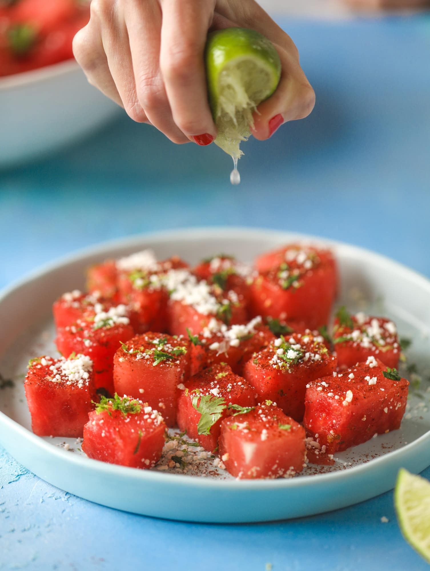 This chili lime watermelon is the perfect summer snack! It's savory and sweet with crumbled cotija cheese and lots of lime. Delish!