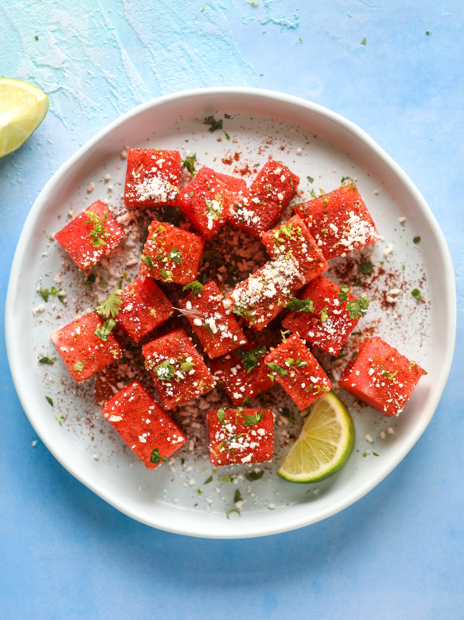 This chili lime watermelon is the perfect summer snack! It's savory and sweet with crumbled cotija cheese and lots of lime. Delish!