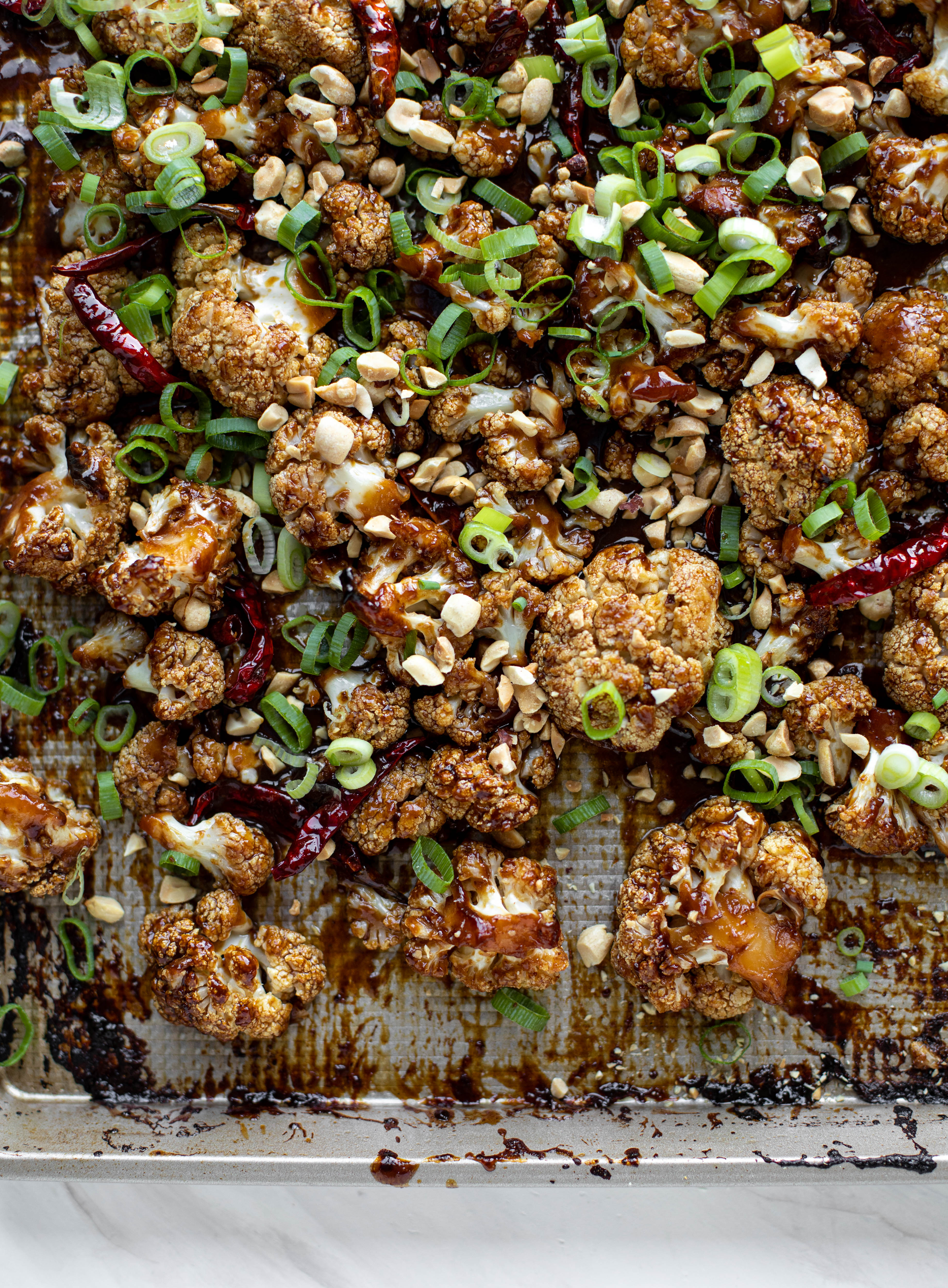 This kung pao cauliflower recipe is roasted on one sheet pan and covered in a delicious sauce! Serve alongside jasmine rice for the best dinner ever.