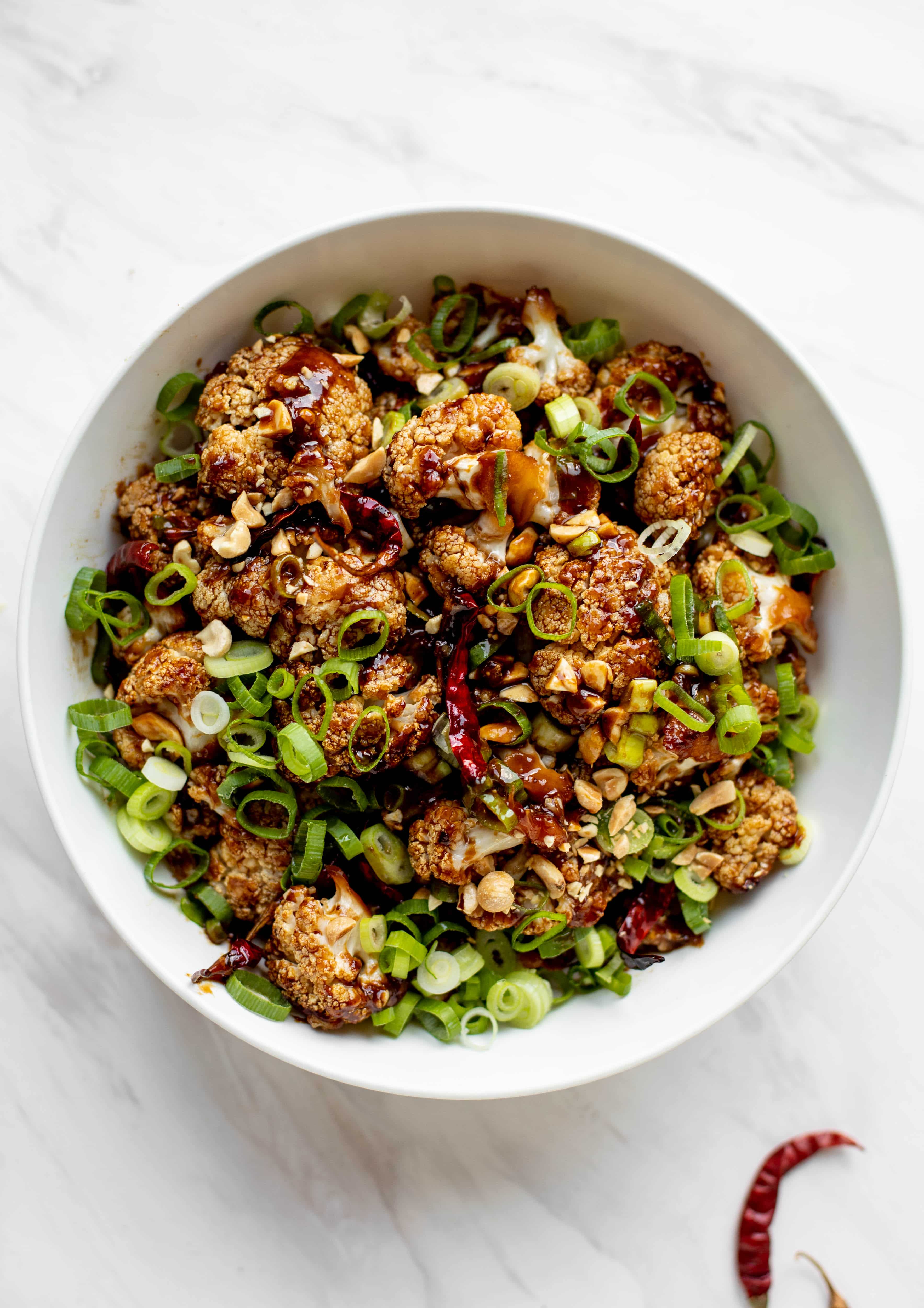 This kung pao cauliflower recipe is roasted on one sheet pan and covered in a delicious sauce! Serve alongside jasmine rice for the best dinner ever.