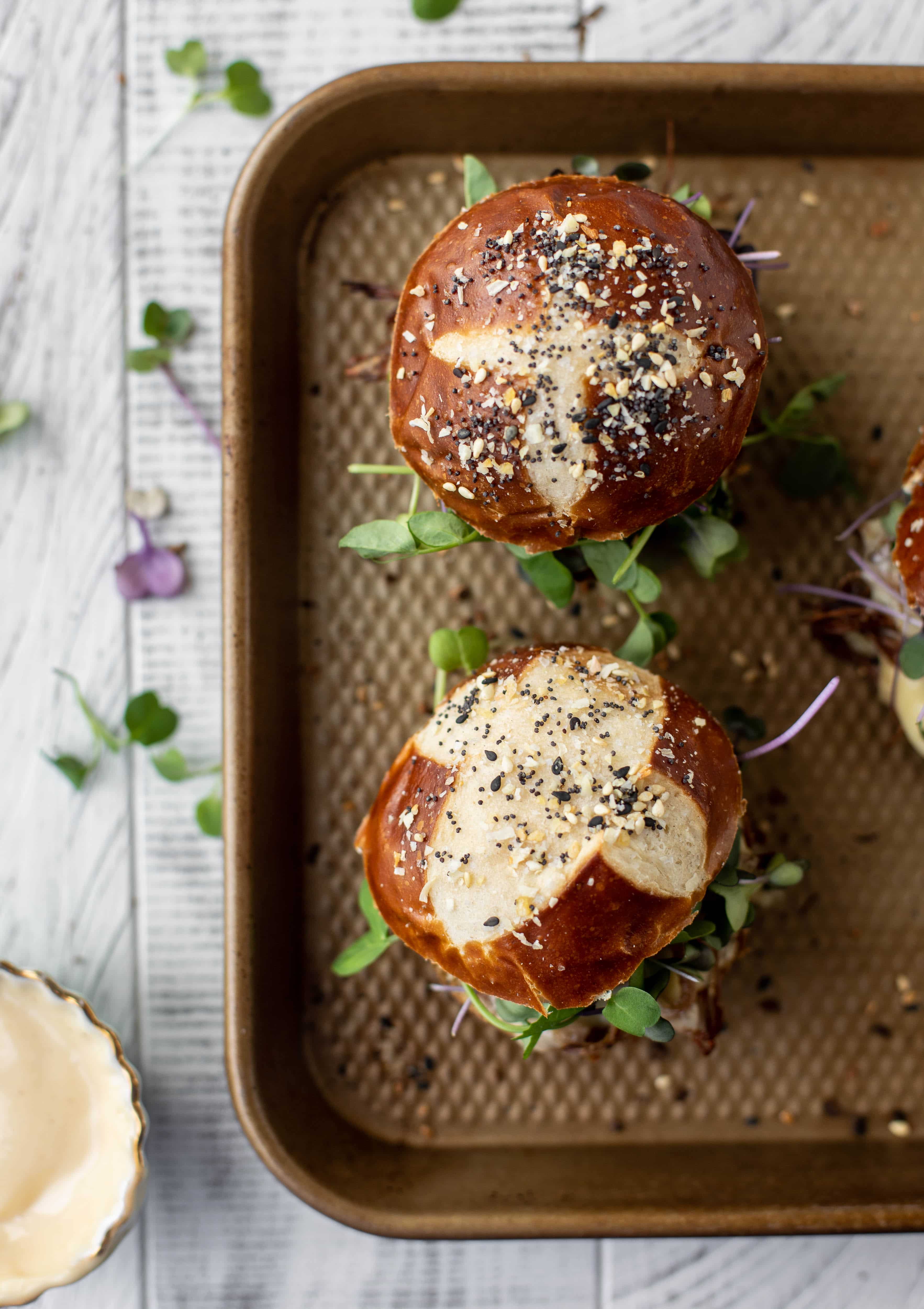 This pumpkin beer brisket melts are smothered in havarti cheese and served on everything pretzel rolls. They are ridiculously delicious!