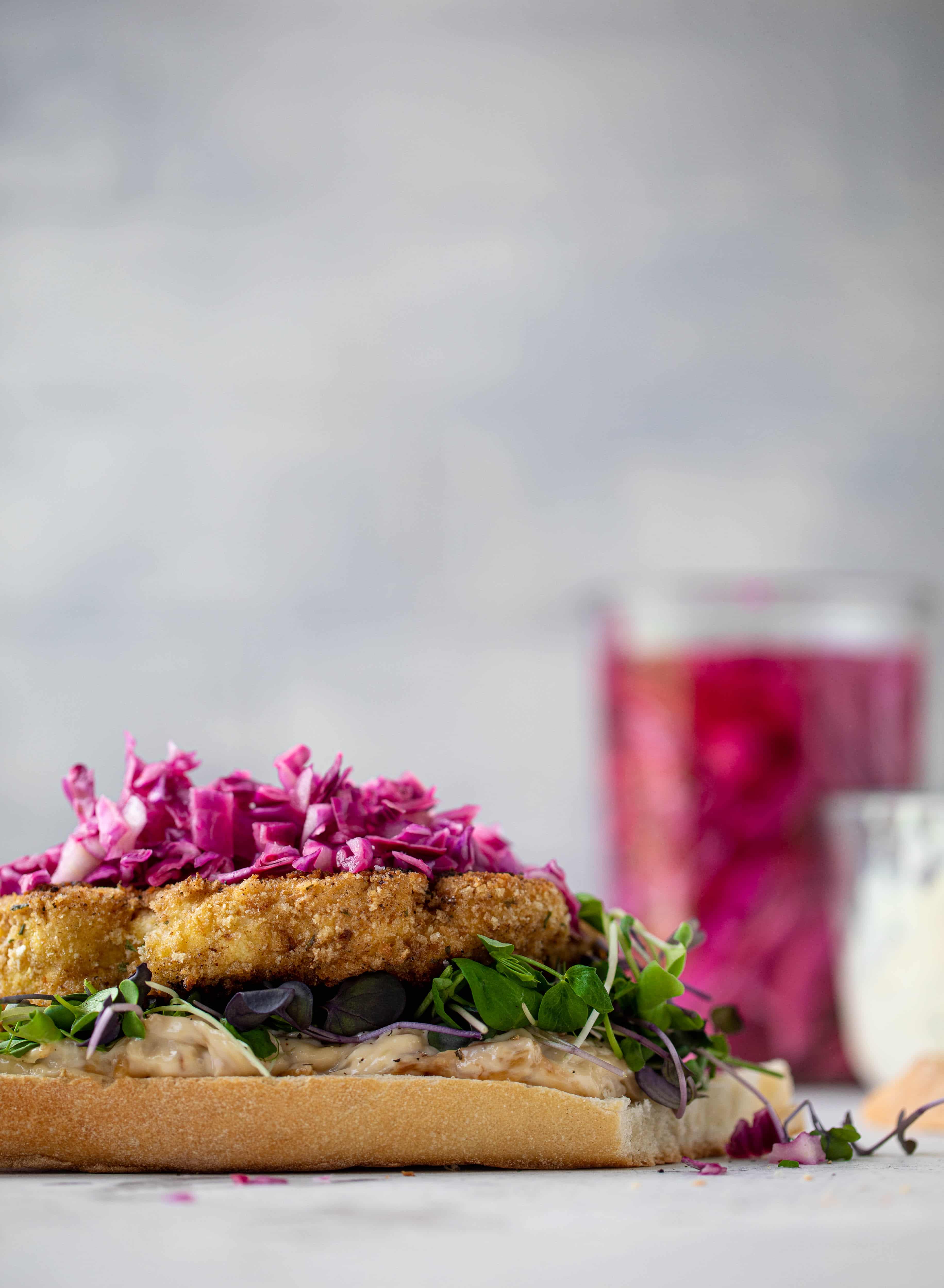 These cauliflower schnitzel sandwiches are full of flavor! Crispy cauliflower, caramelized onion mayo, pickled cabbage and microgreens. Delish!