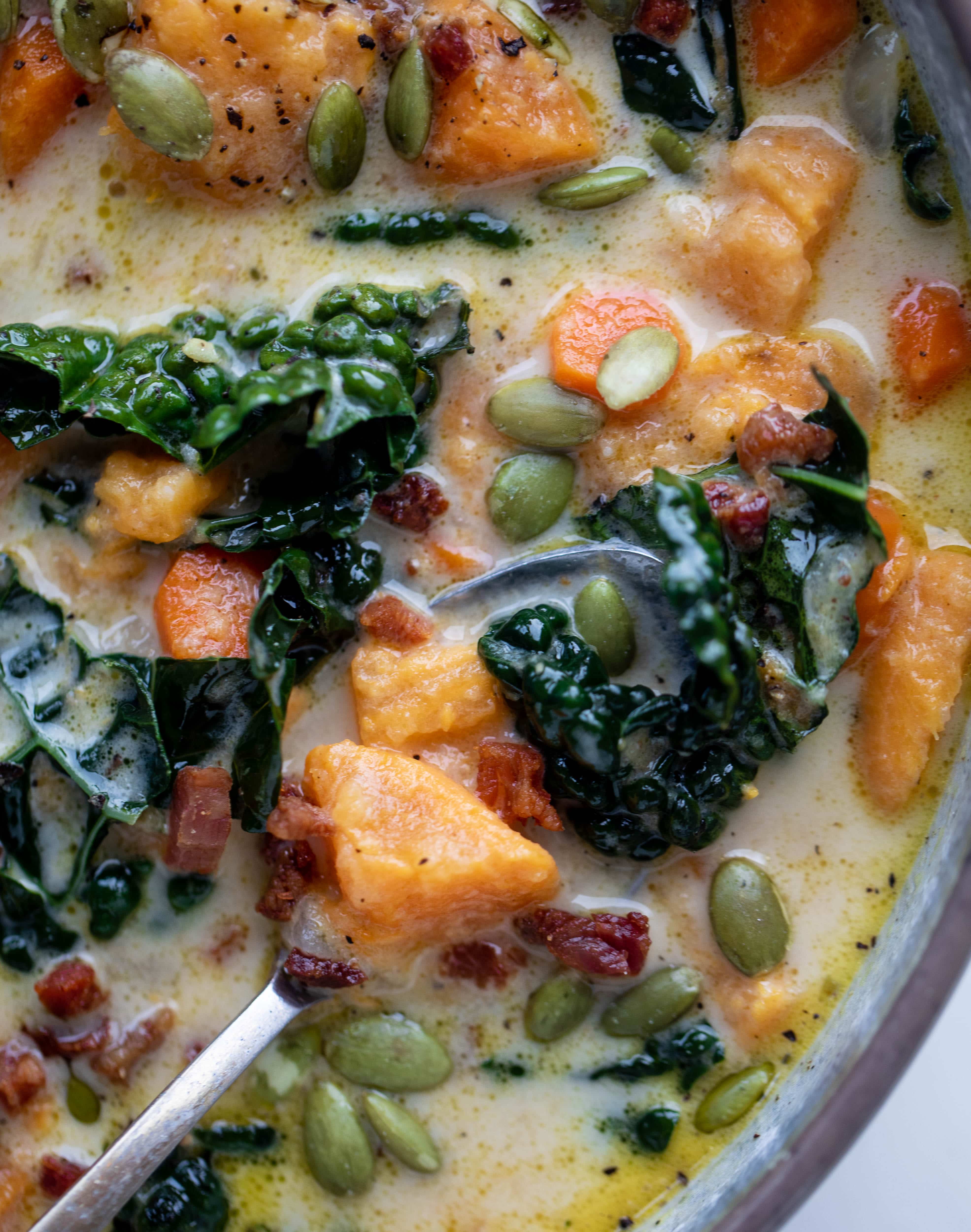 This sweet potato chowder is a hug in a bowl! Made with lots of greens and crunchy pancetta and pepitas for topping, it's a perfect weeknight meal.