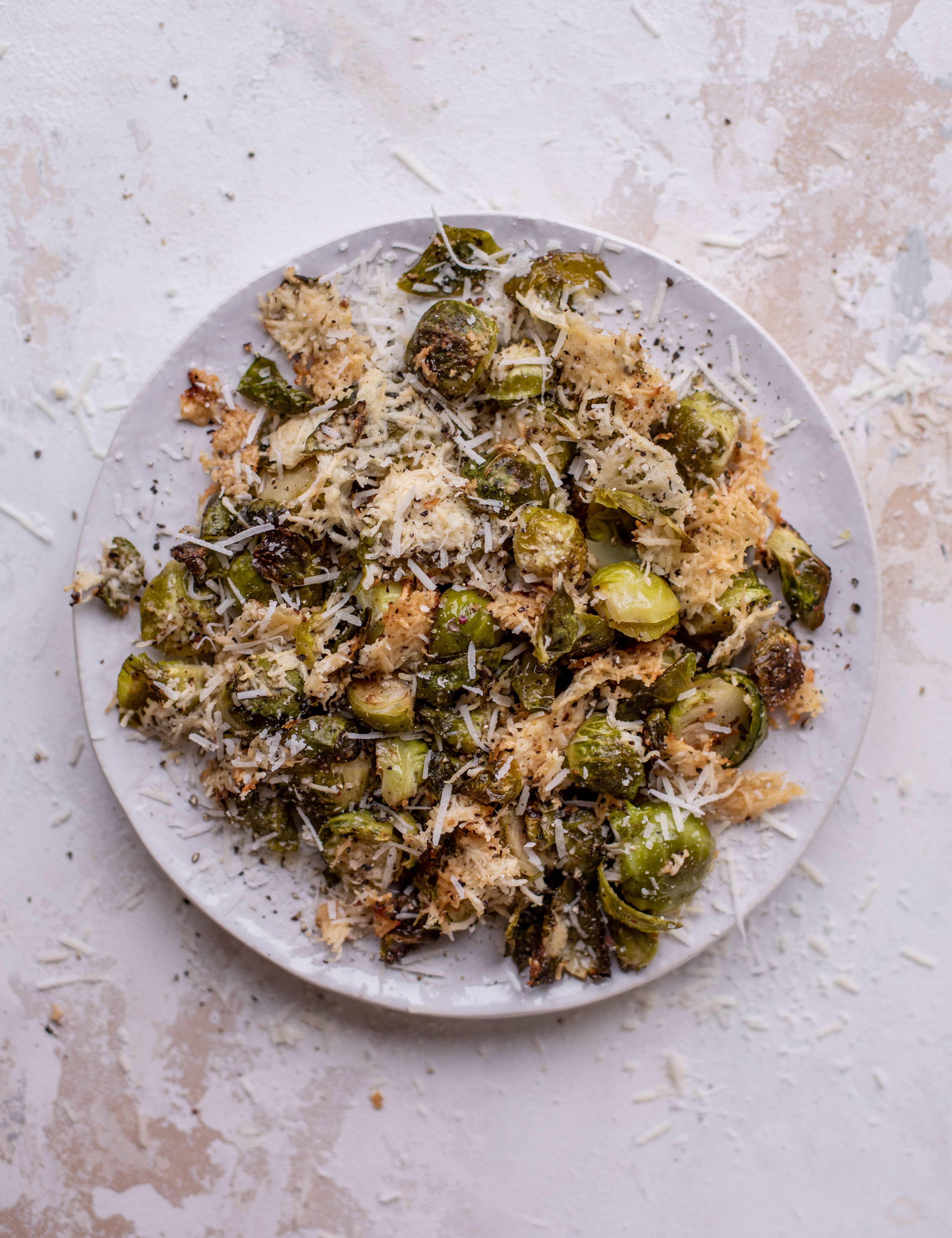 This cacio e pepe brussels are out of the world. Roasted until crisp, topped with tons of black pepper and salty pecorino cheese. Yum.