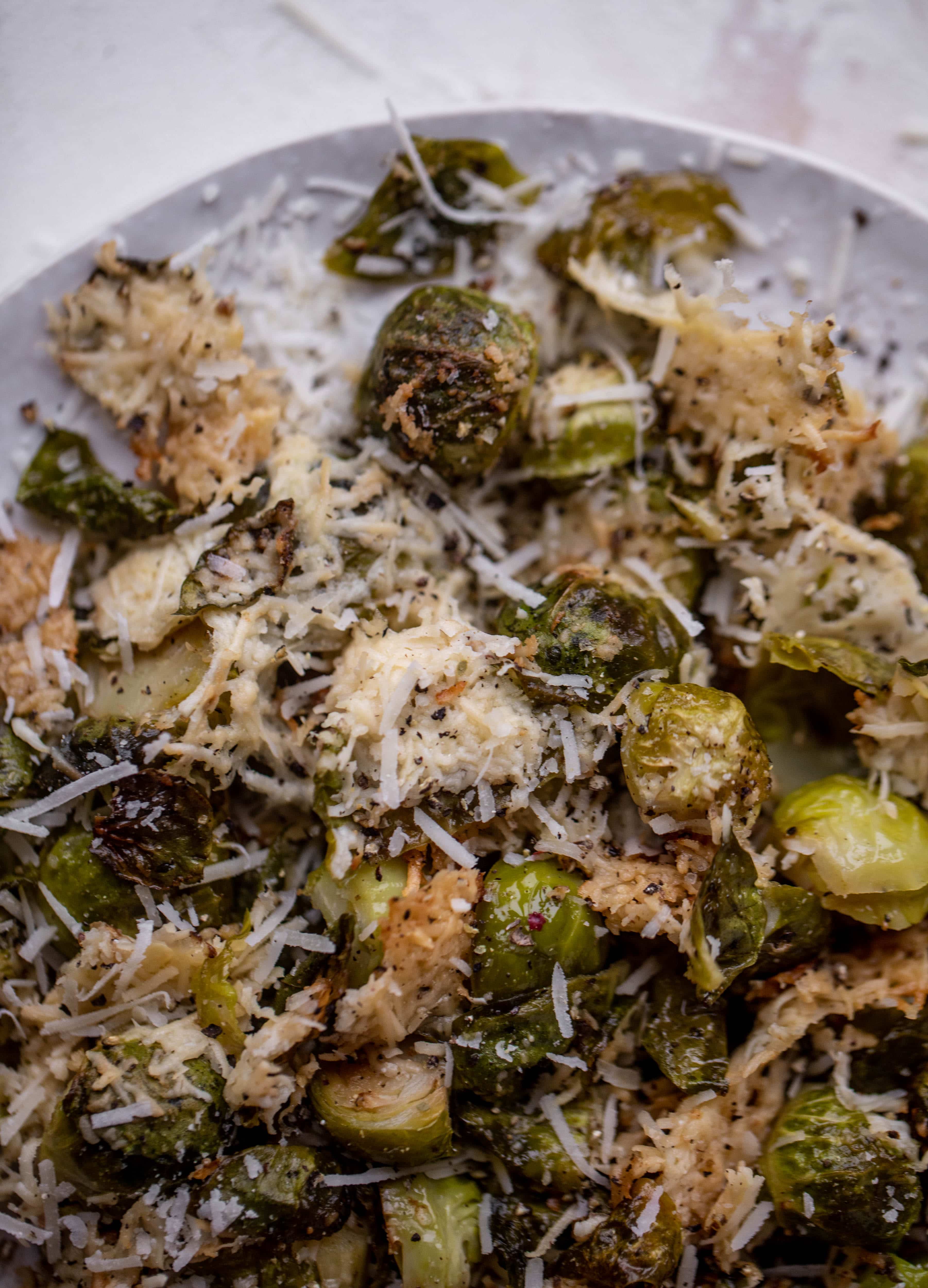 This cacio e pepe brussels are out of the world. Roasted until crisp, topped with tons of black pepper and salty pecorino cheese. Yum.