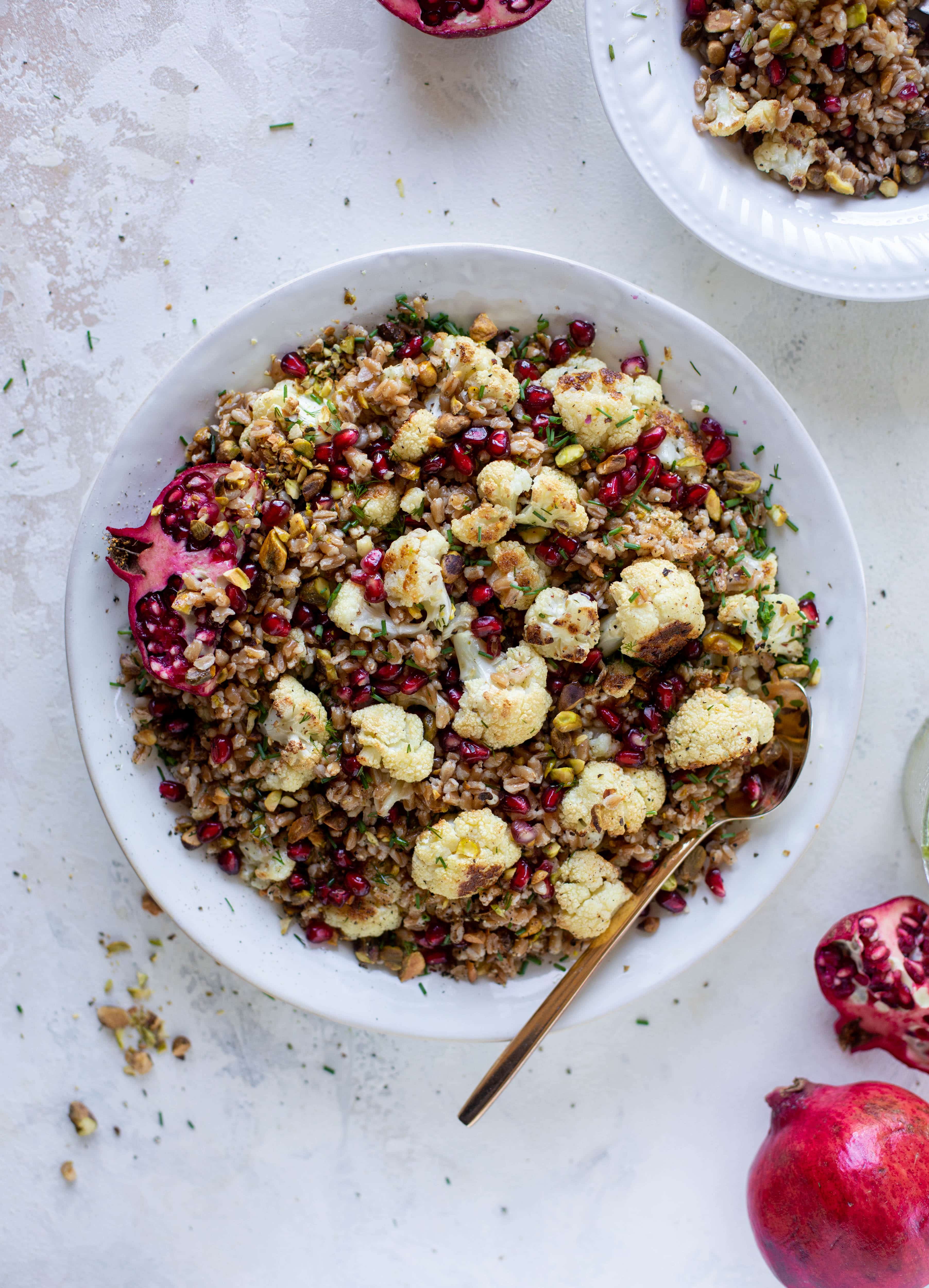 This cauliflower farro salad is filled with roasted cauliflower, pistachios, pomegranates and drizzled with a dill vinaigrette. Delicious!