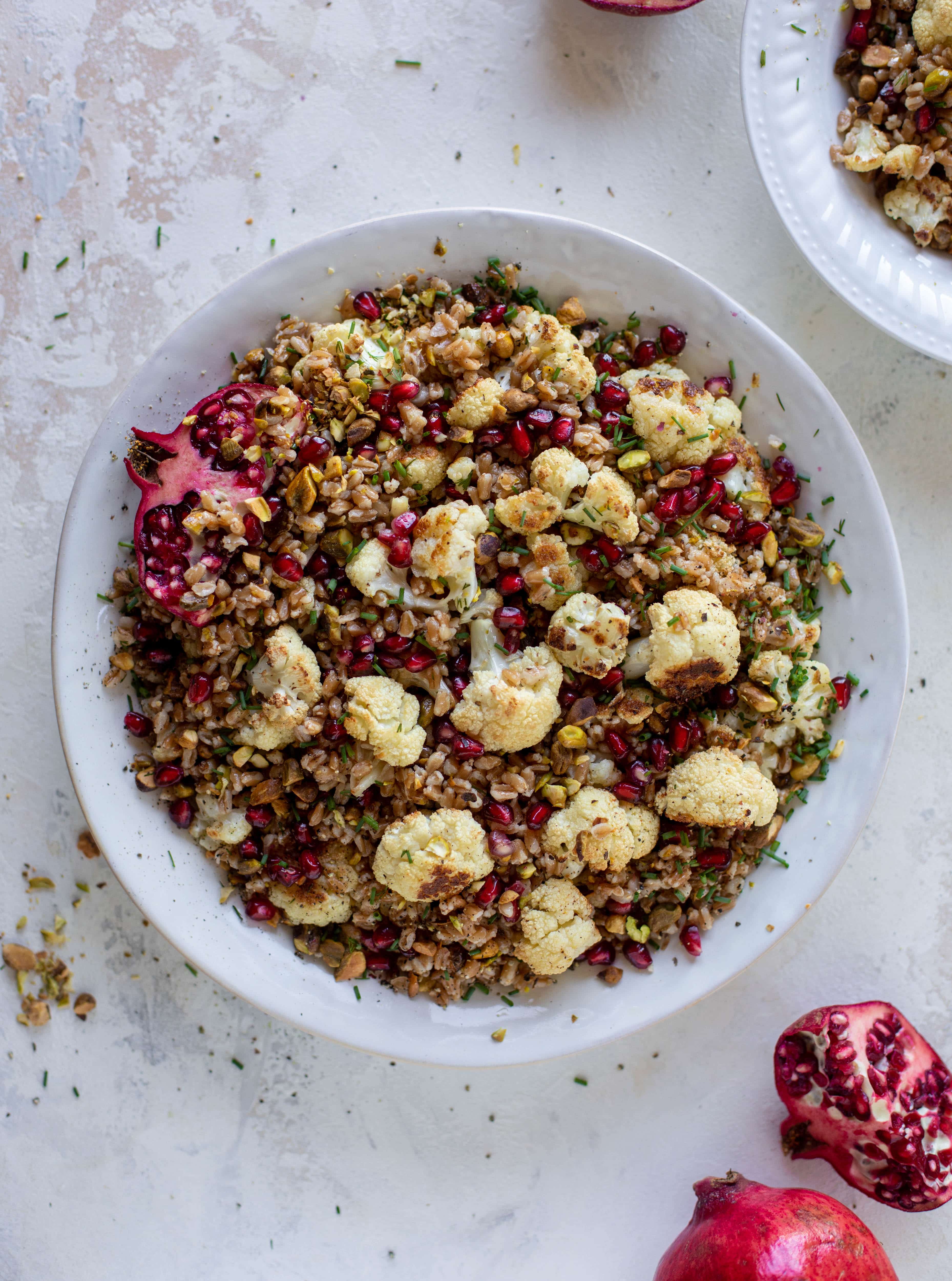 This cauliflower farro salad is filled with roasted cauliflower, pistachios, pomegranates and drizzled with a dill vinaigrette. Delicious!