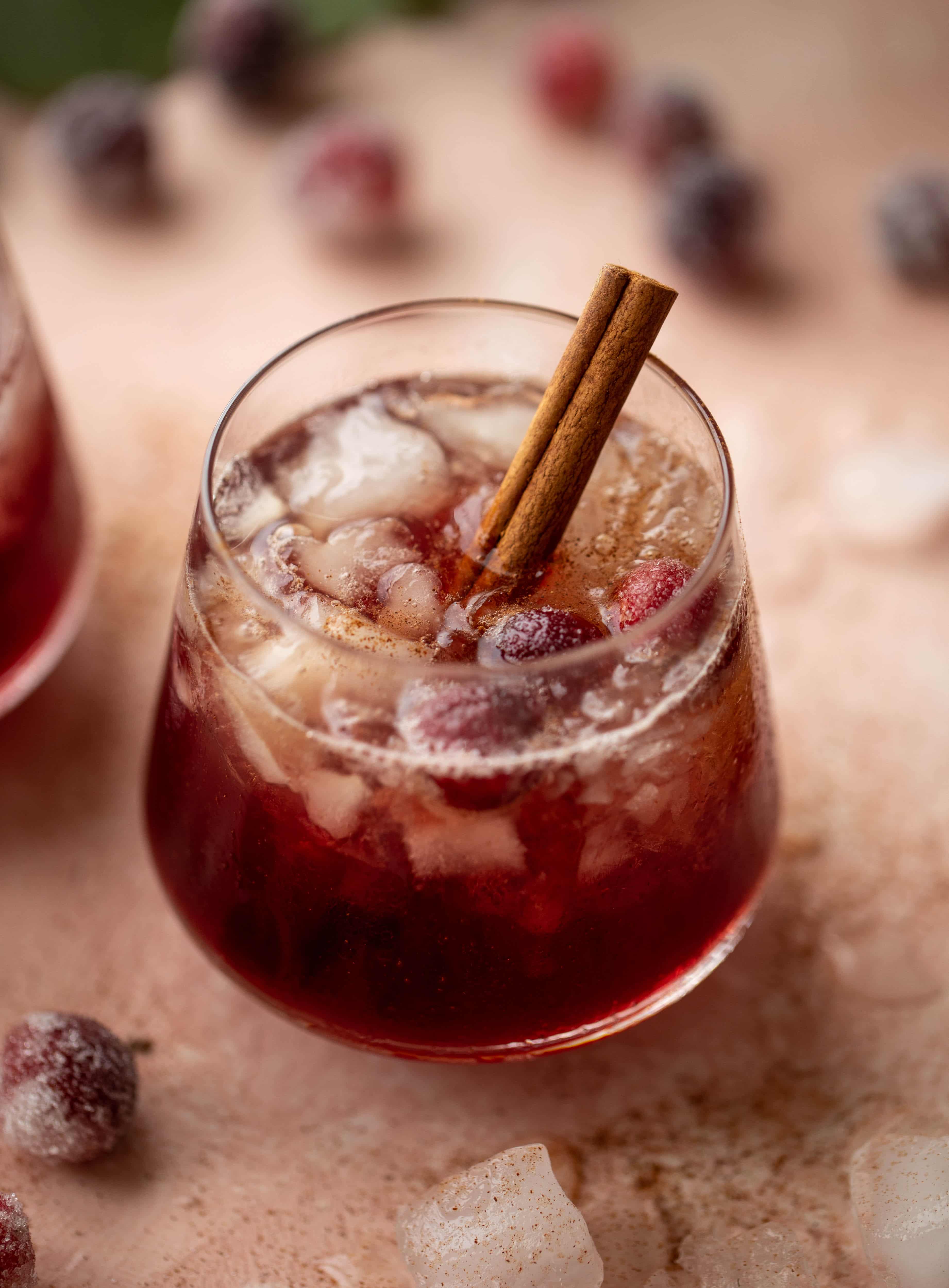 This cranberry cobbler smash is perfect for the holiday season! Bourbon, cinnamon simple syrup and cranberry juice - it's spiced and warming and wonderful.