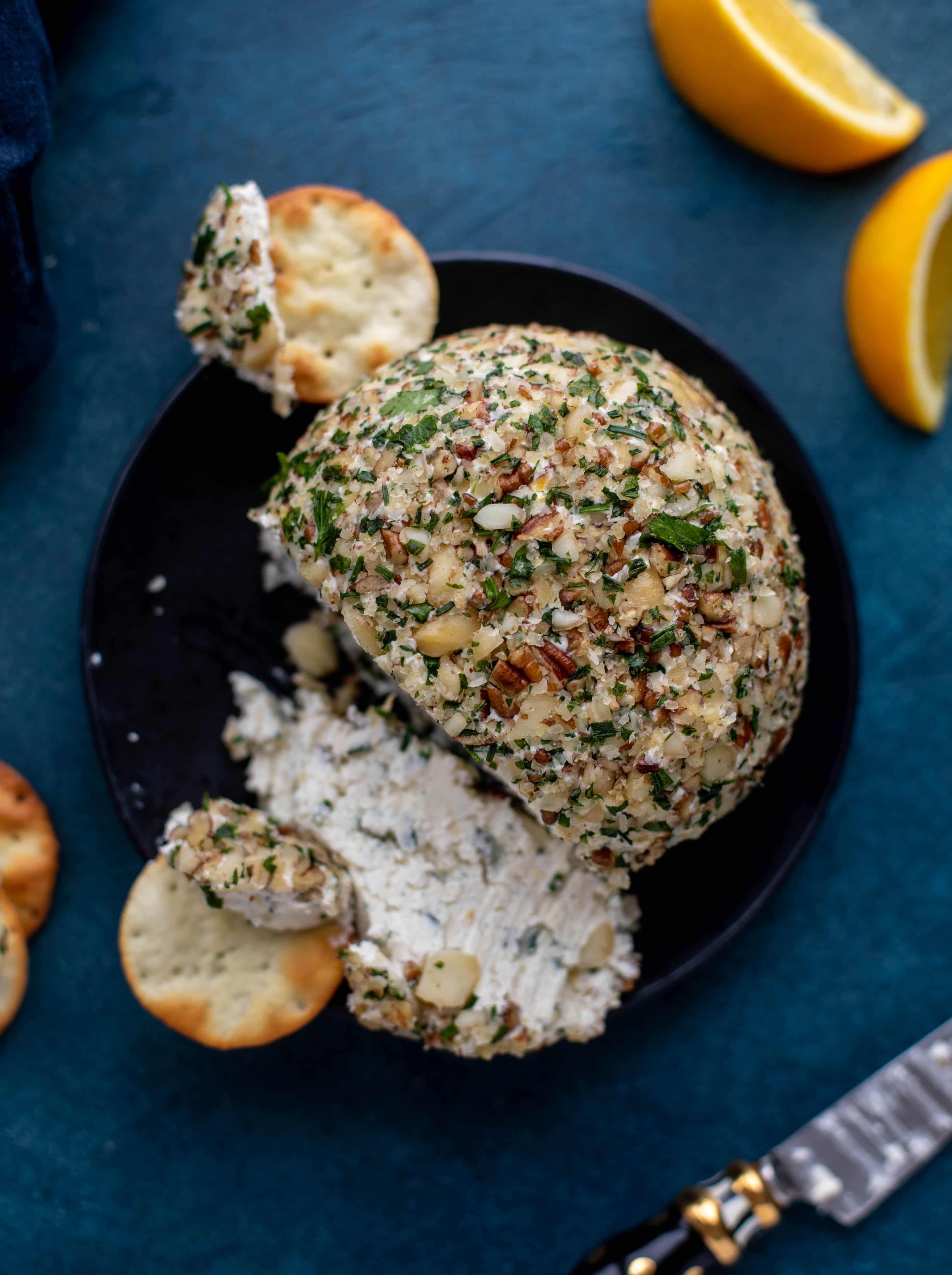 This macadamia nut cheeseball is flavored with fresh orange, spices, crispy sage and pecorino cheese. It's the perfect make-ahead snack!