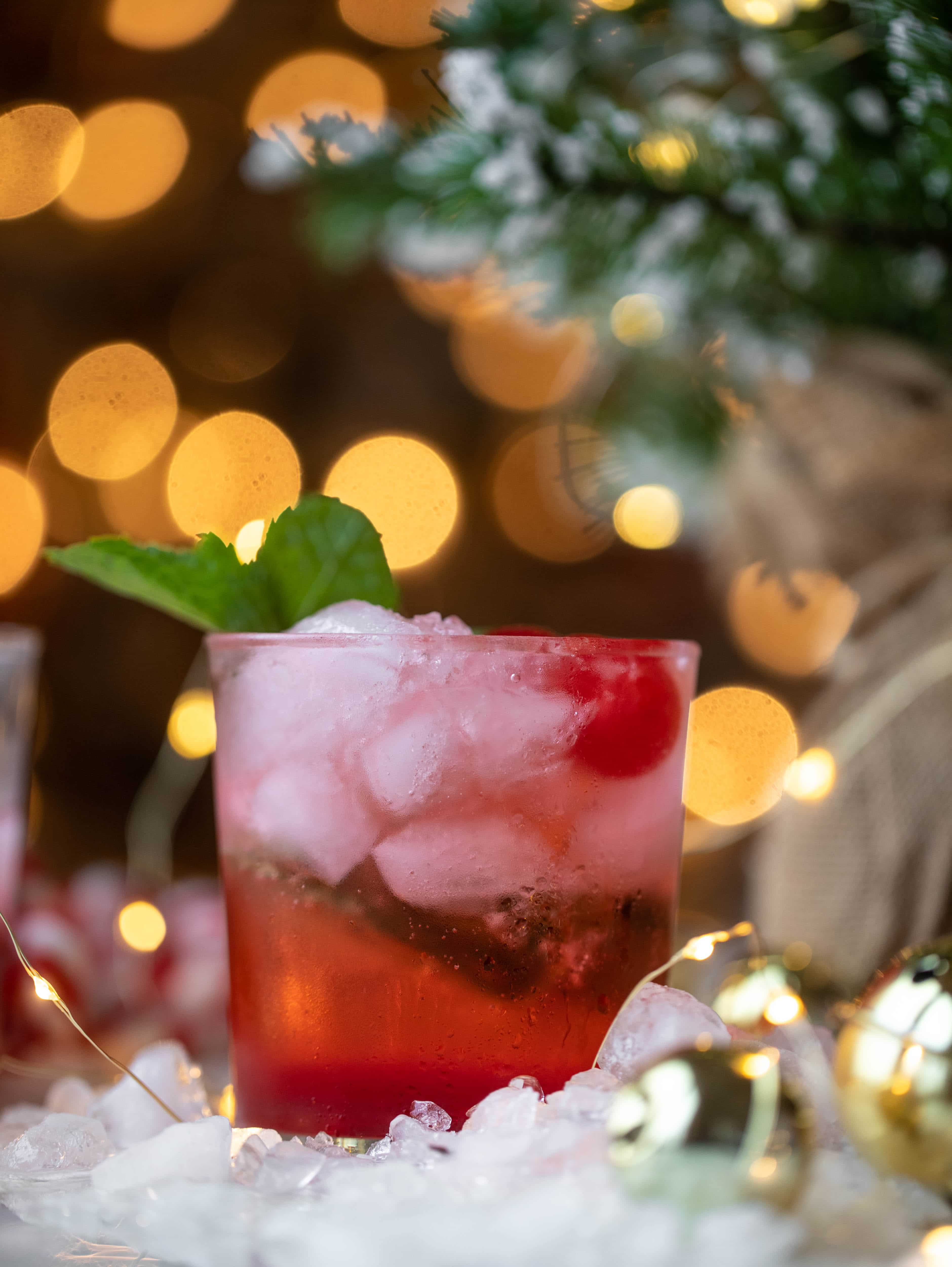 The merry cherry christmas cocktail is here! Vodka and cherries and mint, oh my! This is such a fun drink that can be made into a punch. It's delicious!