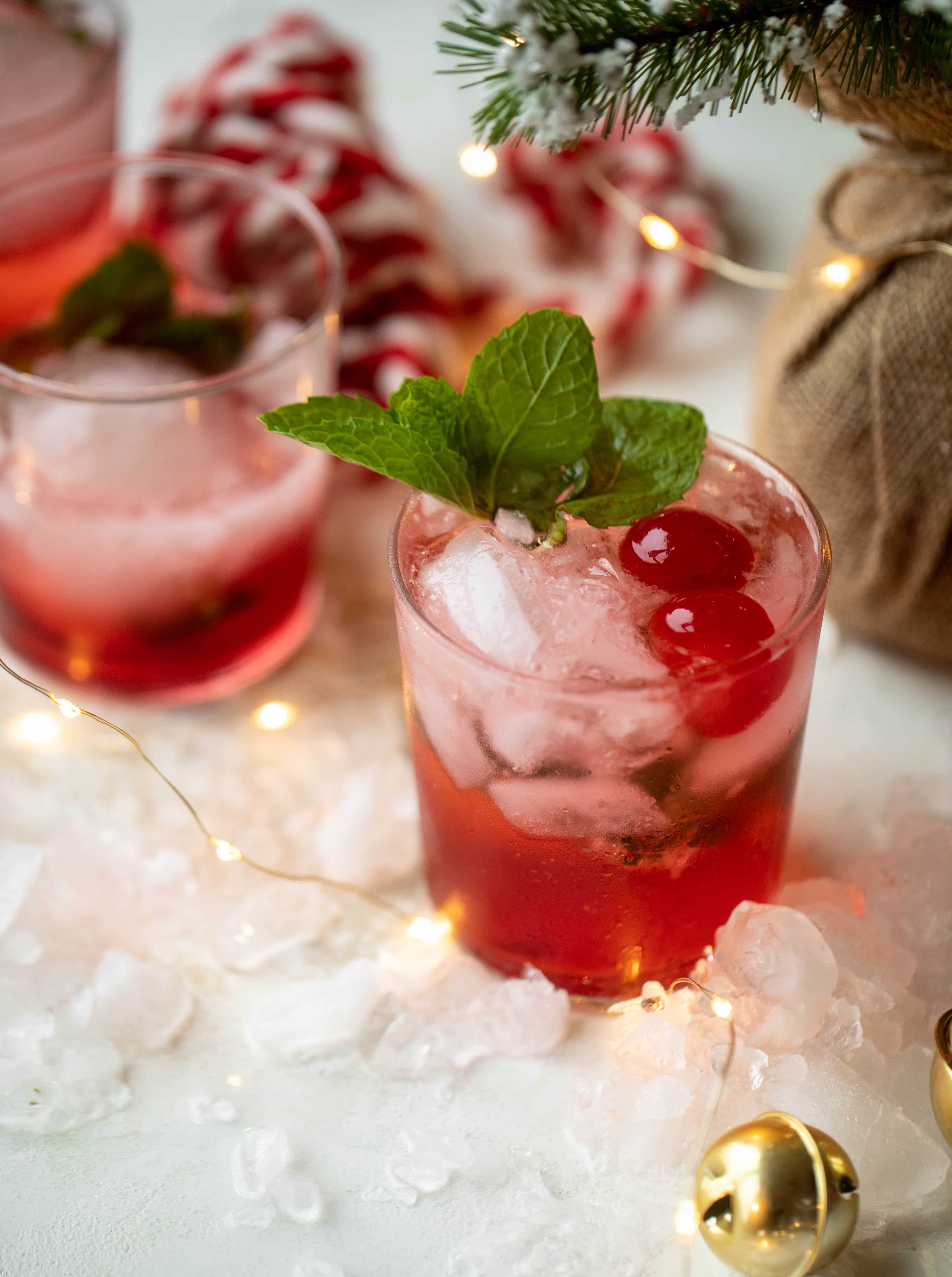 The merry cherry christmas cocktail is here! Vodka and cherries and mint, oh my! This is such a fun drink that can be made into a punch. It's delicious!