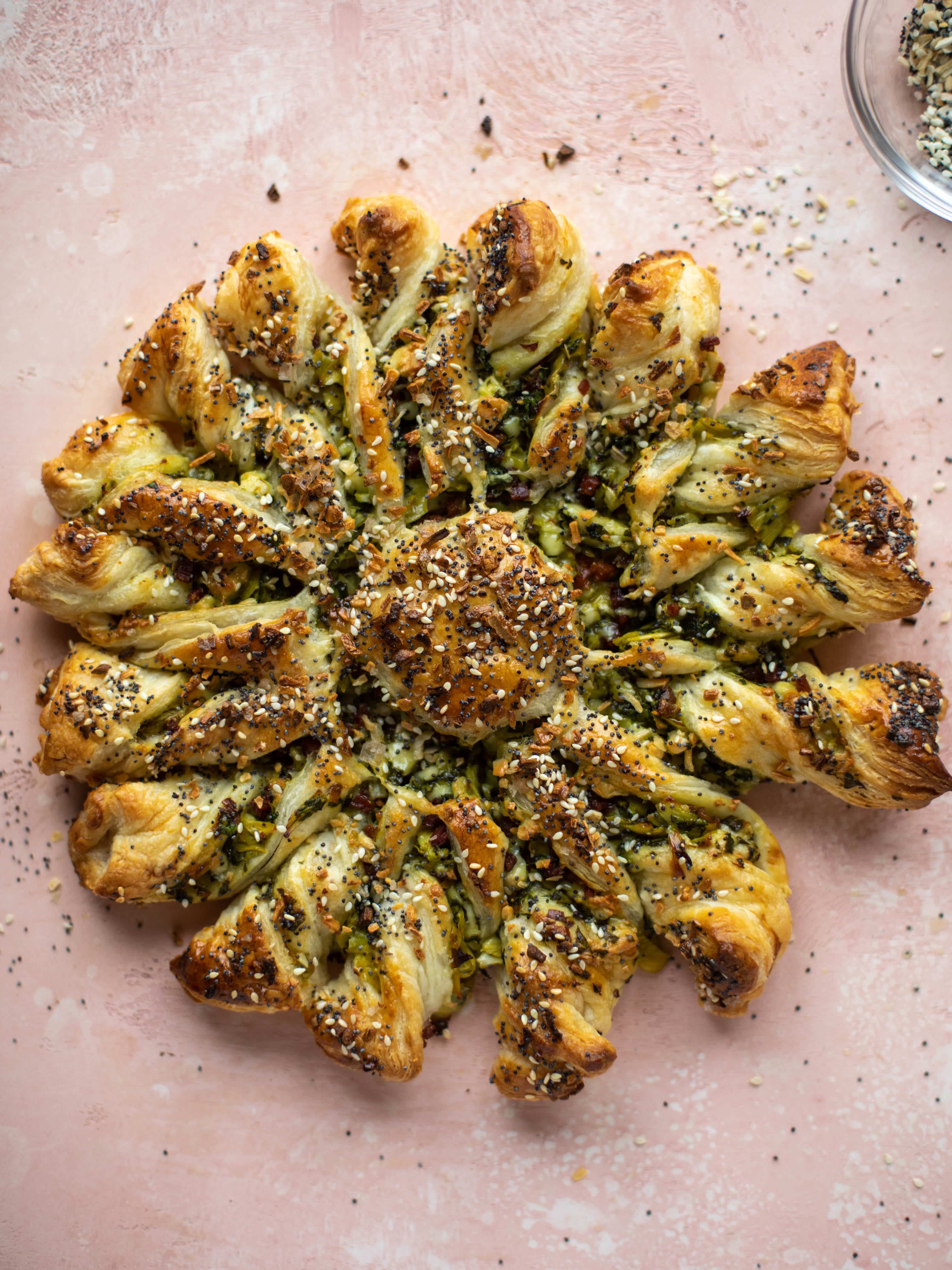 These spinach artichoke twists are filled with cheese and pancetta. They are buttery and flaky on the outside then sprinkled with everything seasoning. YUM.