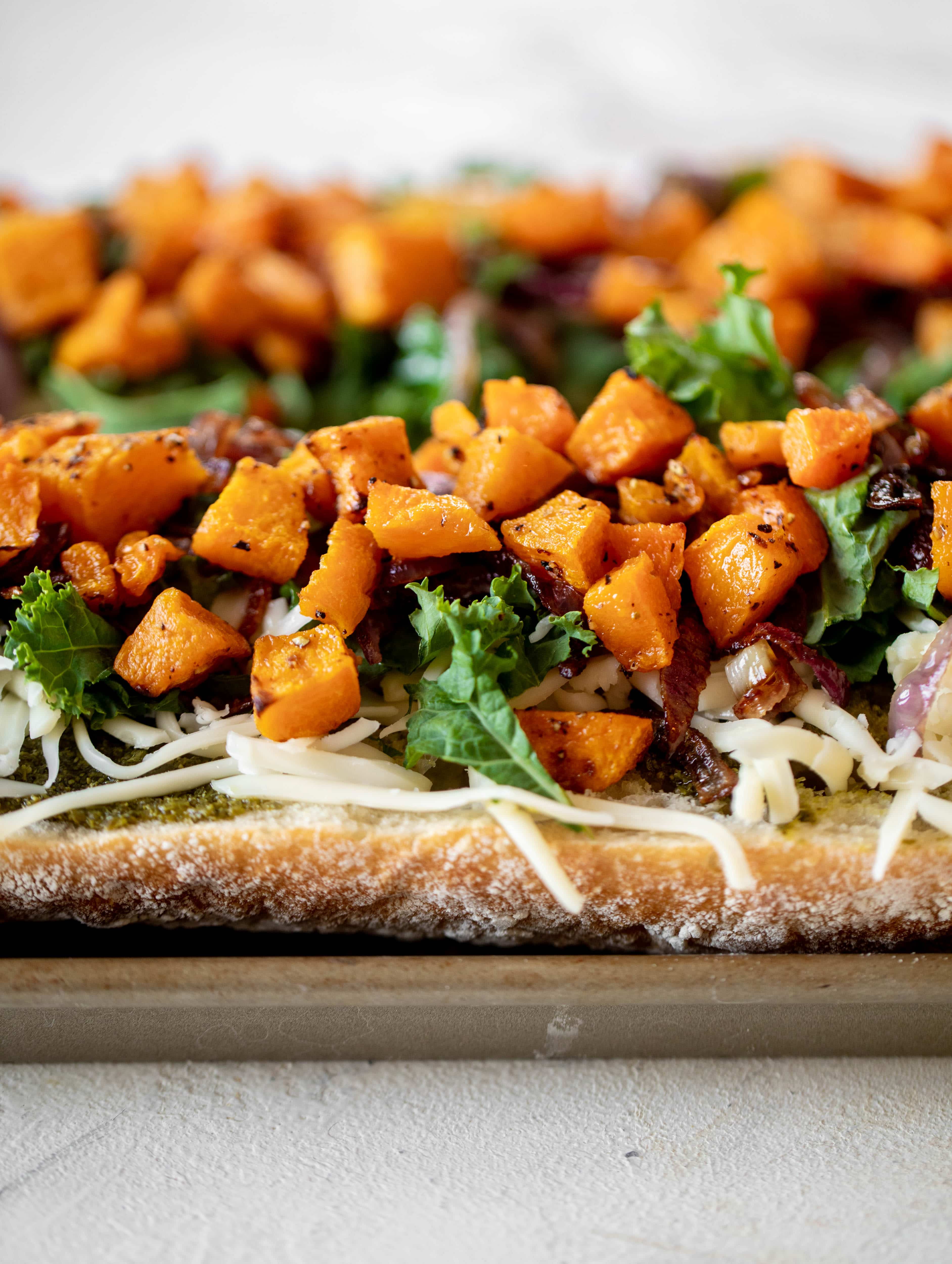 These butternut squash french breads have so much flavor. Pesto, caramelized onions, kale, roasted butternut and tons of fontina cheese. Delicious! 