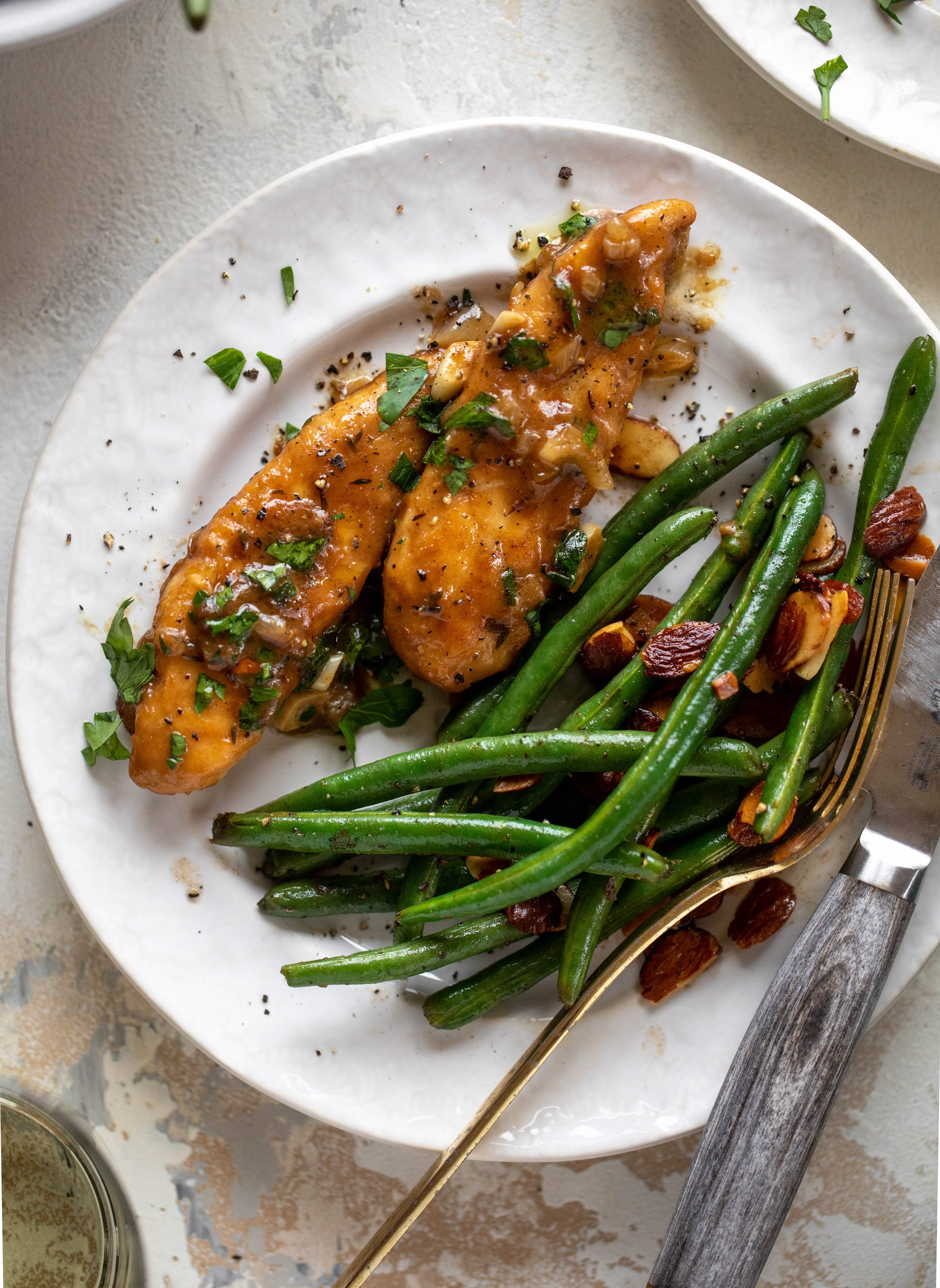 My mom's chicken marsala is easy and ridiculously flavorful! It's made without mushrooms and served alongside almond brown butter green beans.