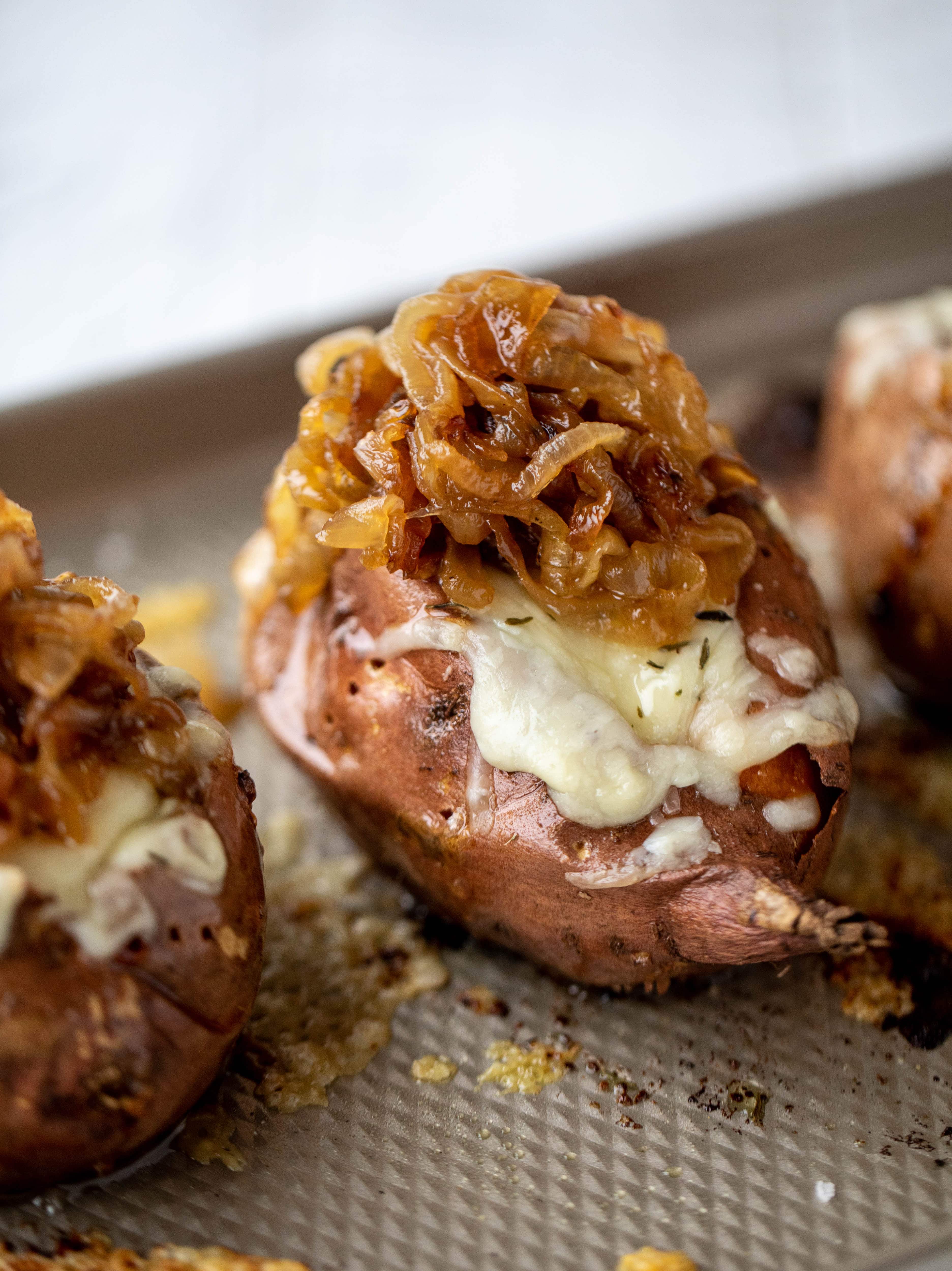 These french onion stuffed sweet potatoes are slow roasted and topped with gruyere cheese and caramelized onions. Garlic butter bread crumbs finish them!
