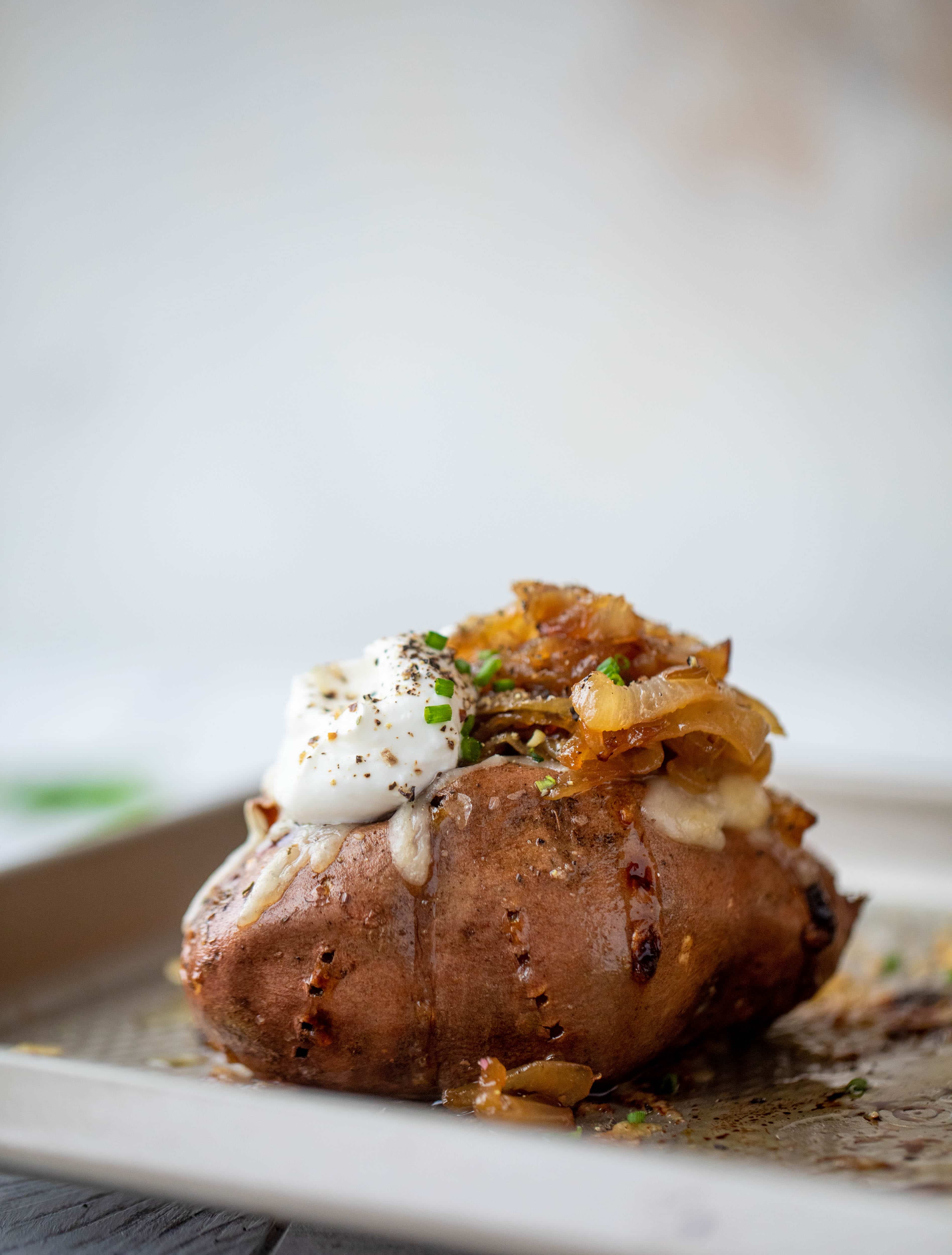 These french onion stuffed sweet potatoes are slow roasted and topped with gruyere cheese and caramelized onions. Garlic butter bread crumbs finish them!