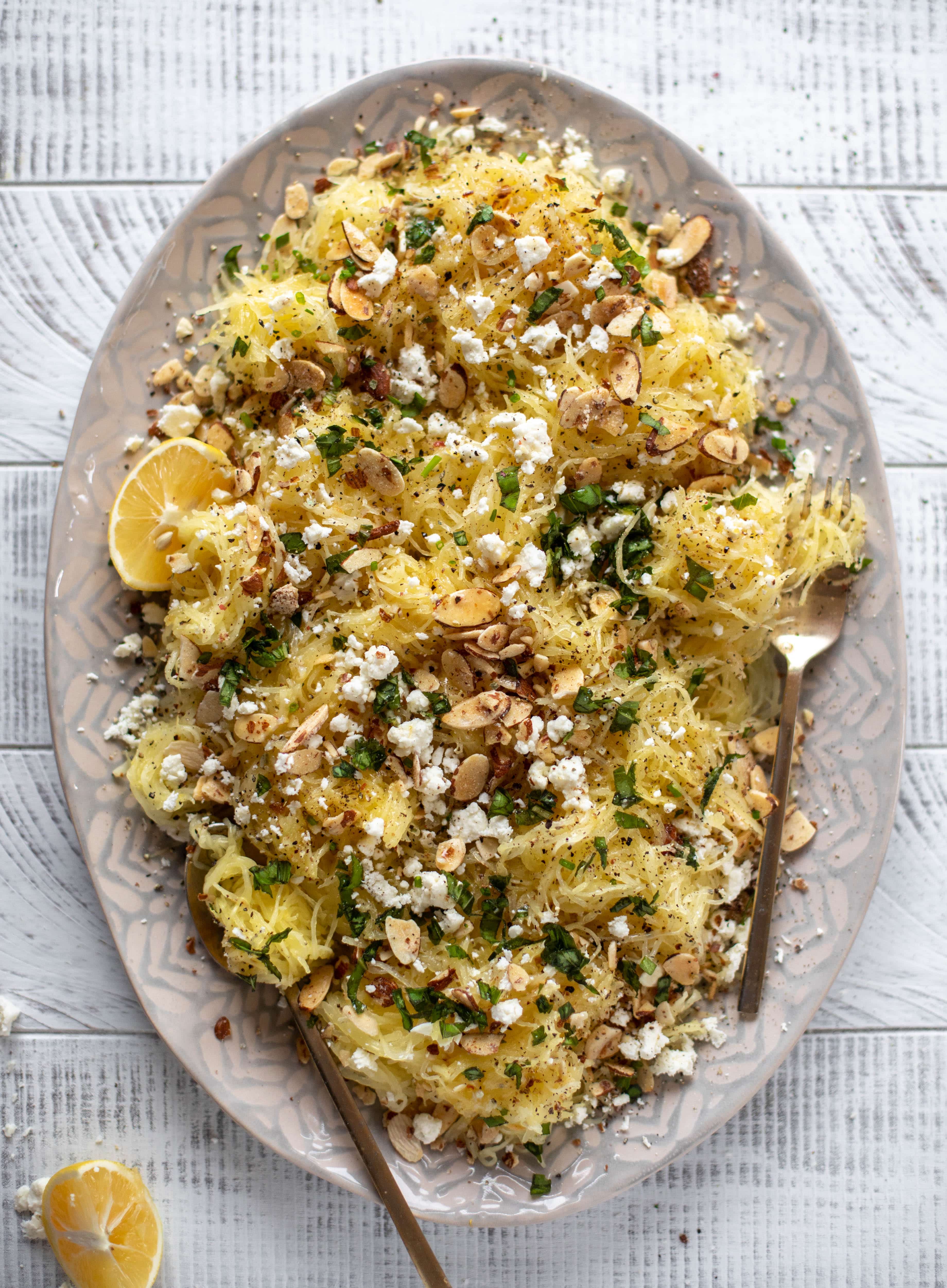 This lemon spaghetti squash is tossed in a lemon garlic butter and topped with feta, sliced toasted almonds and fresh herbs. It's delicious! 