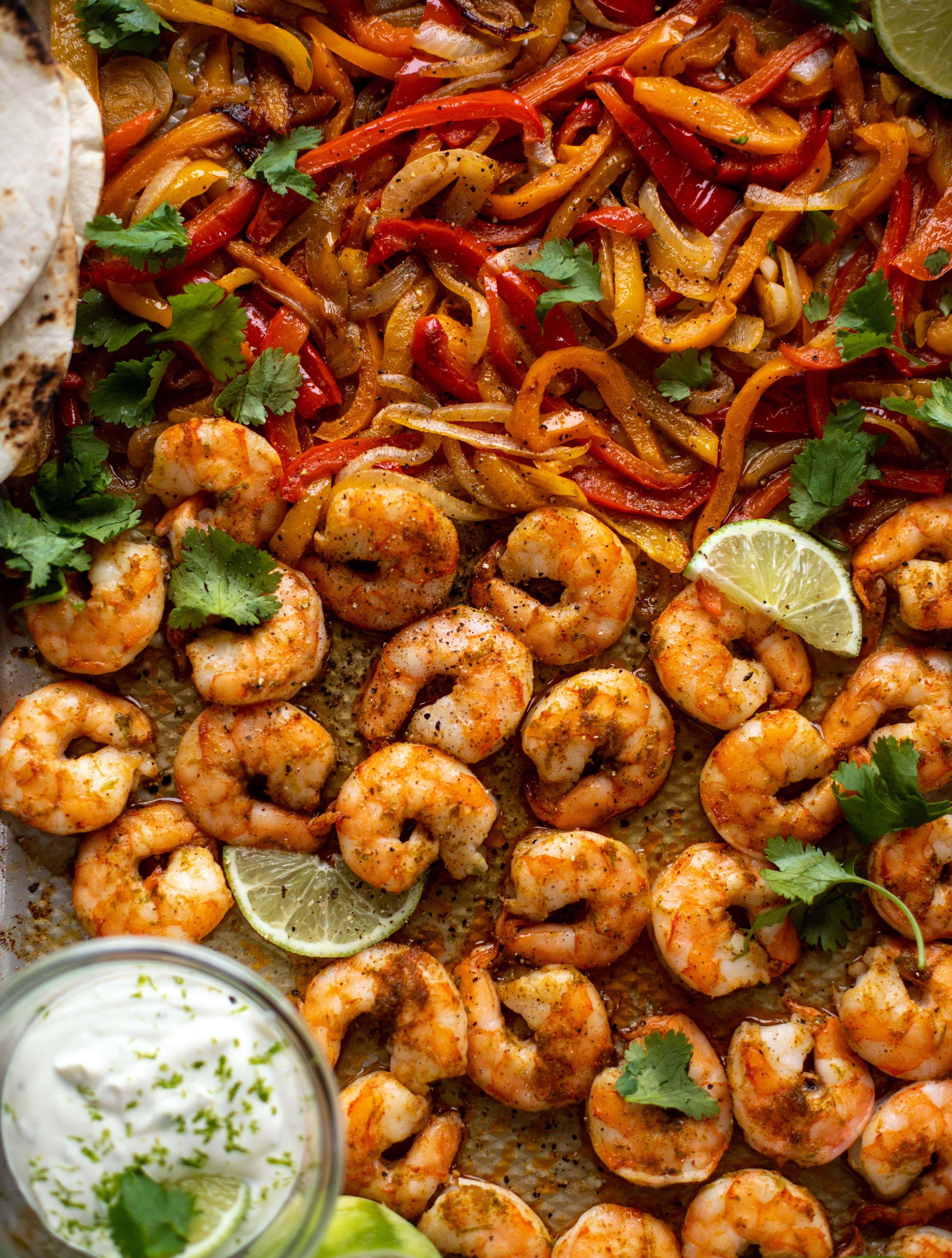 These lime sheet pan shrimp fajitas are the best weeknight meal! Make everything on the sheet pan and serve in warm tortillas. Delicious!