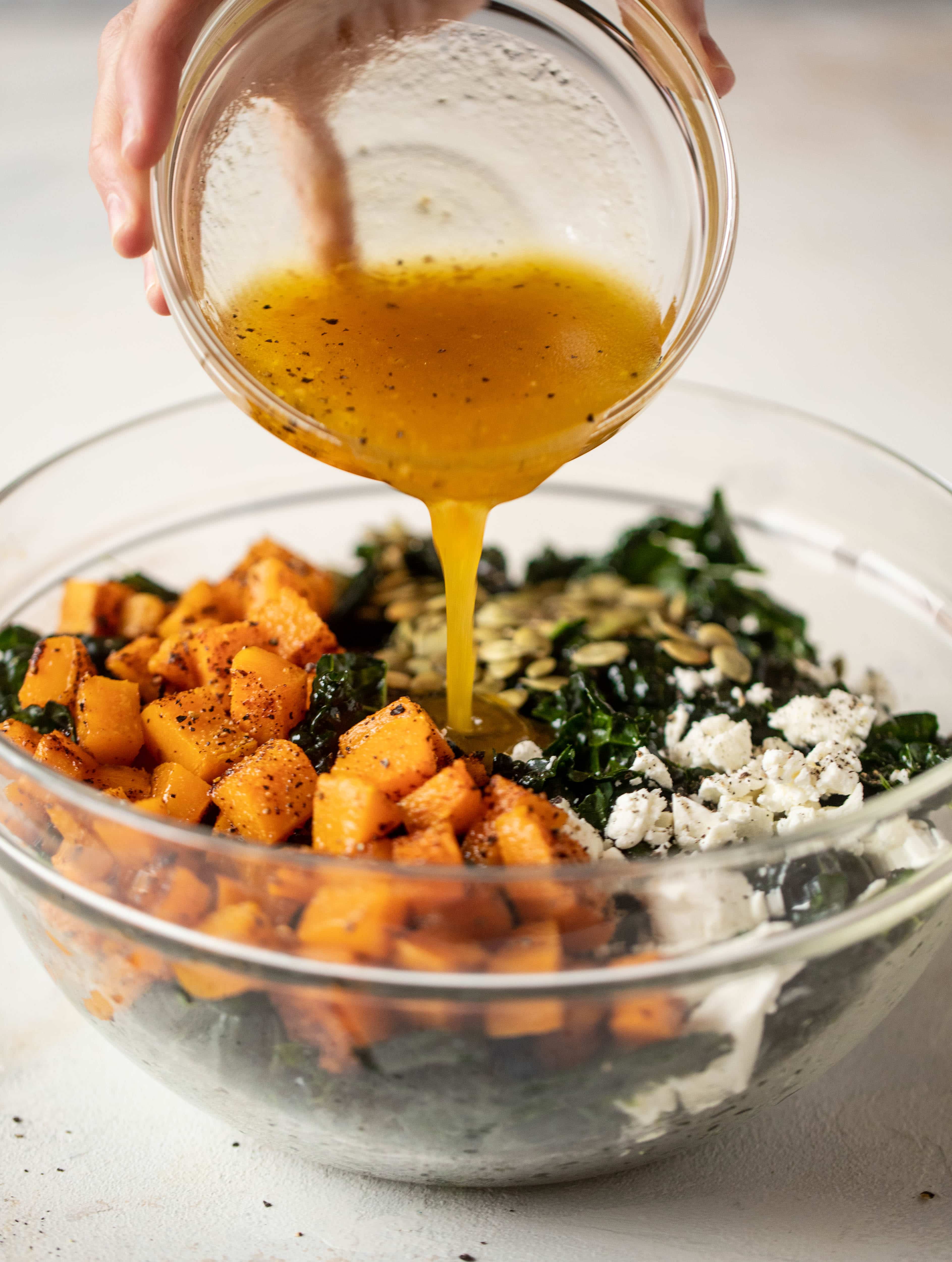 This butternut squash kale salad is so easy and delicious! Roasted, smoky butternut squash, goat cheese, pepitas and apricot vinaigrette.