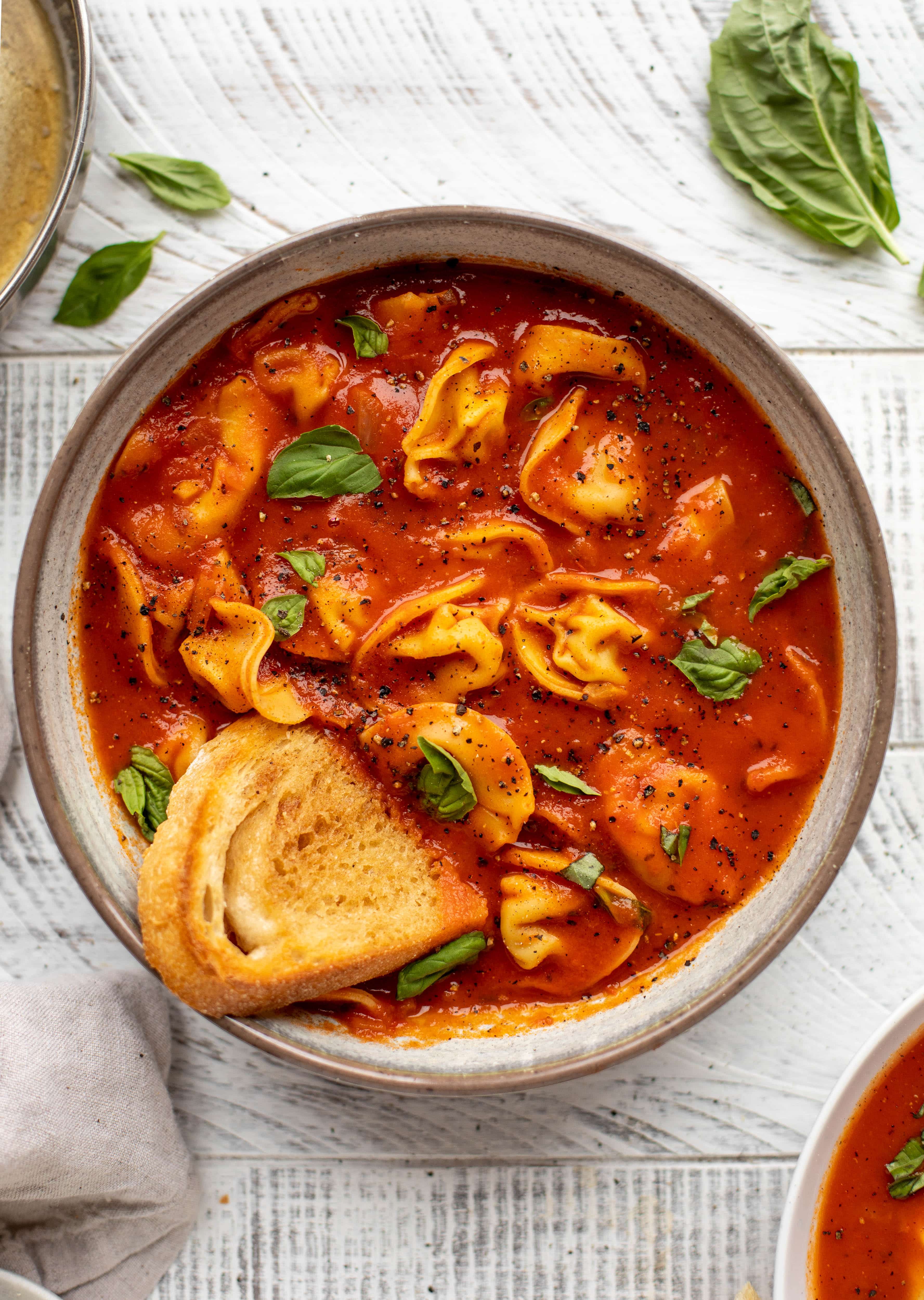 This curried tomato tortellini soup has so much flavor! Serve with cheesy tortellini and brown butter garlic toasts for the perfect weeknight meal.