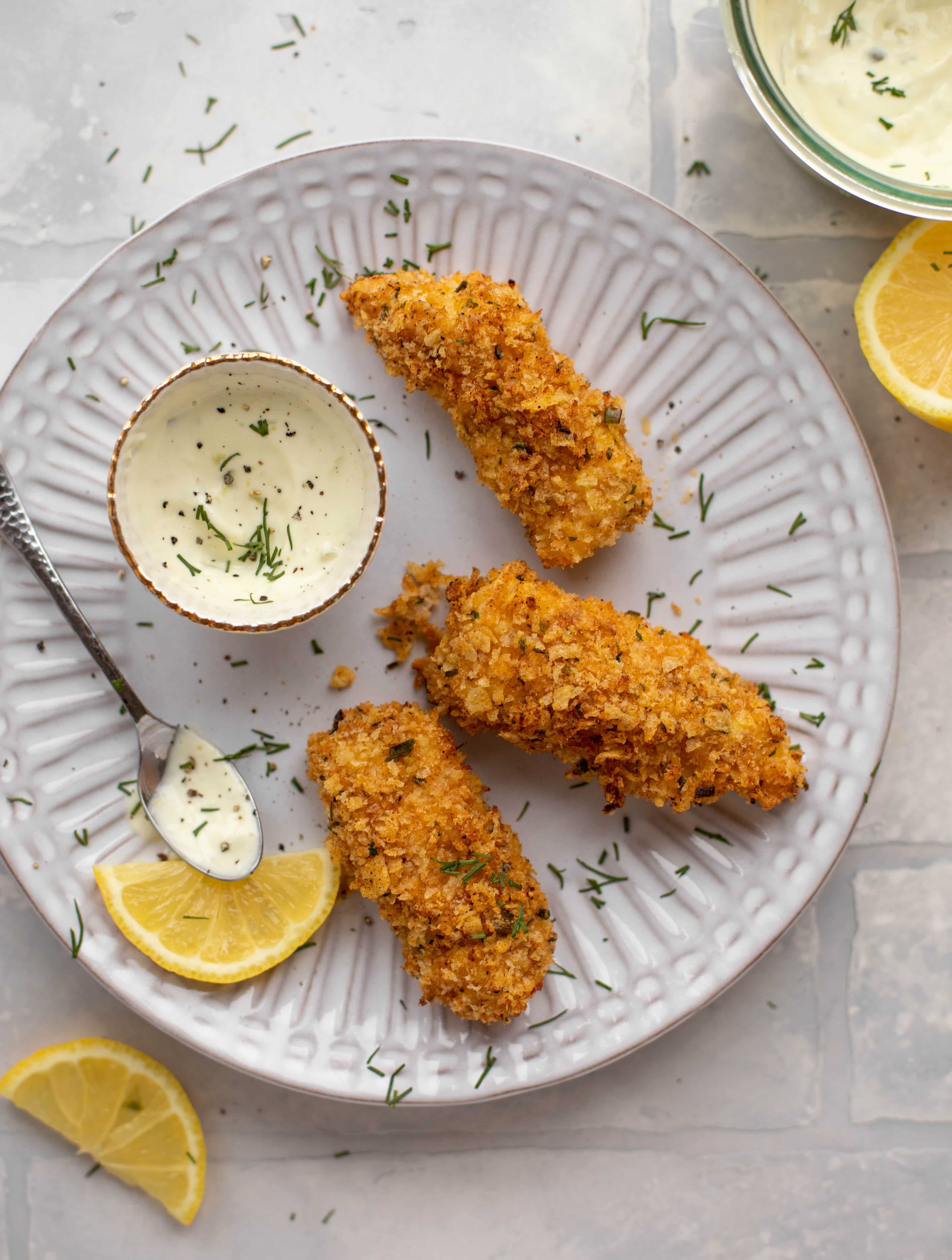These crispy homemade fish sticks are flavored with lemon and garlic! They are super crunchy and delicious when dipped in the jalapeño tartar sauce.