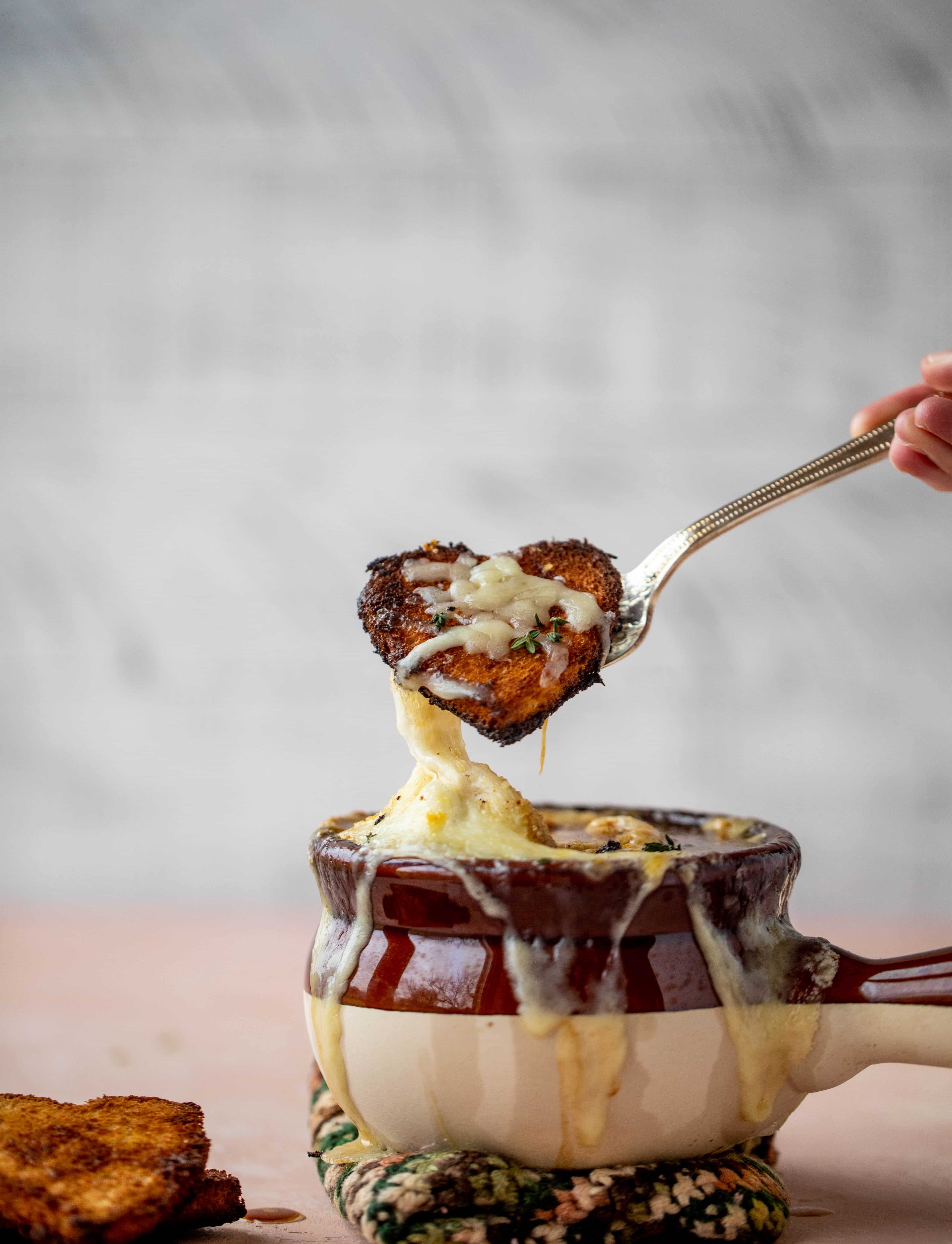 My favorite french onion soup starts with bourbon caramelized onions! Adorable heart croutons and tons of gruyere take it over the top.