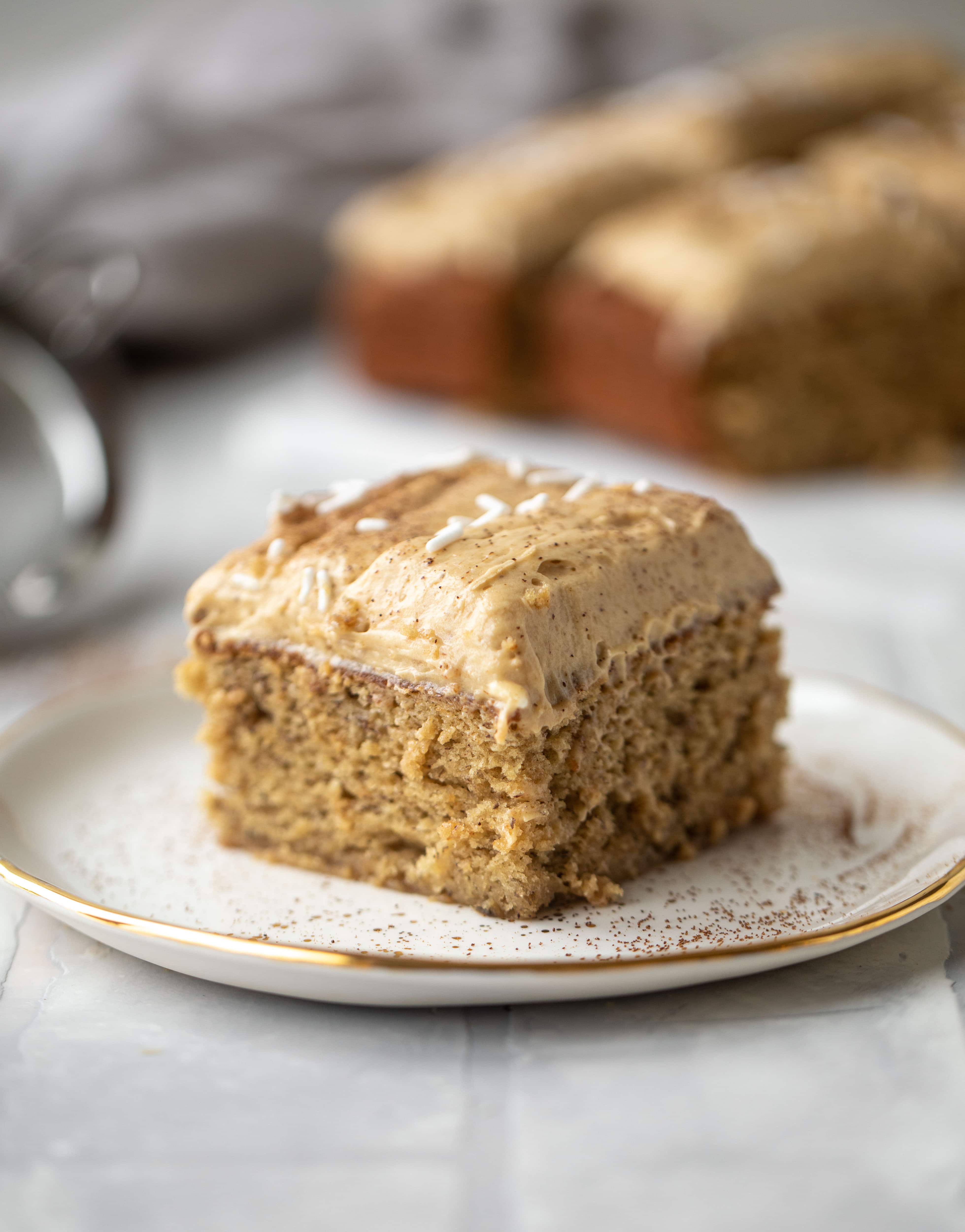 This banana cake is a delicious twist on banana bread! Covered with coffee cream cheese frosting, it’s an easy and wonderful treat.