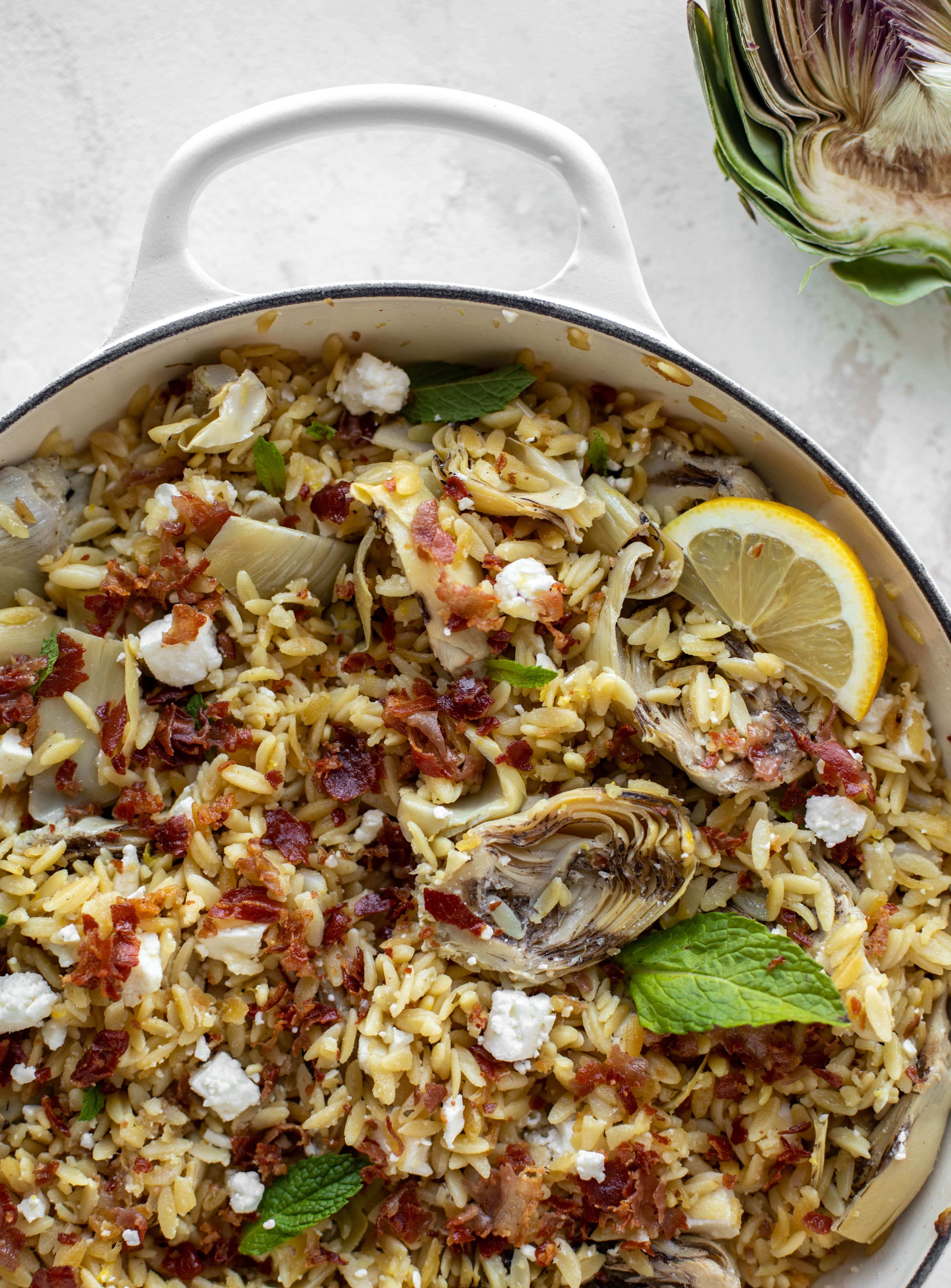 This crispy orzo is a wonderful spring dish. Artichoke hearts, lemon, goat cheese and herbs all topped with a sprinkling of crunchy prosciutto. 