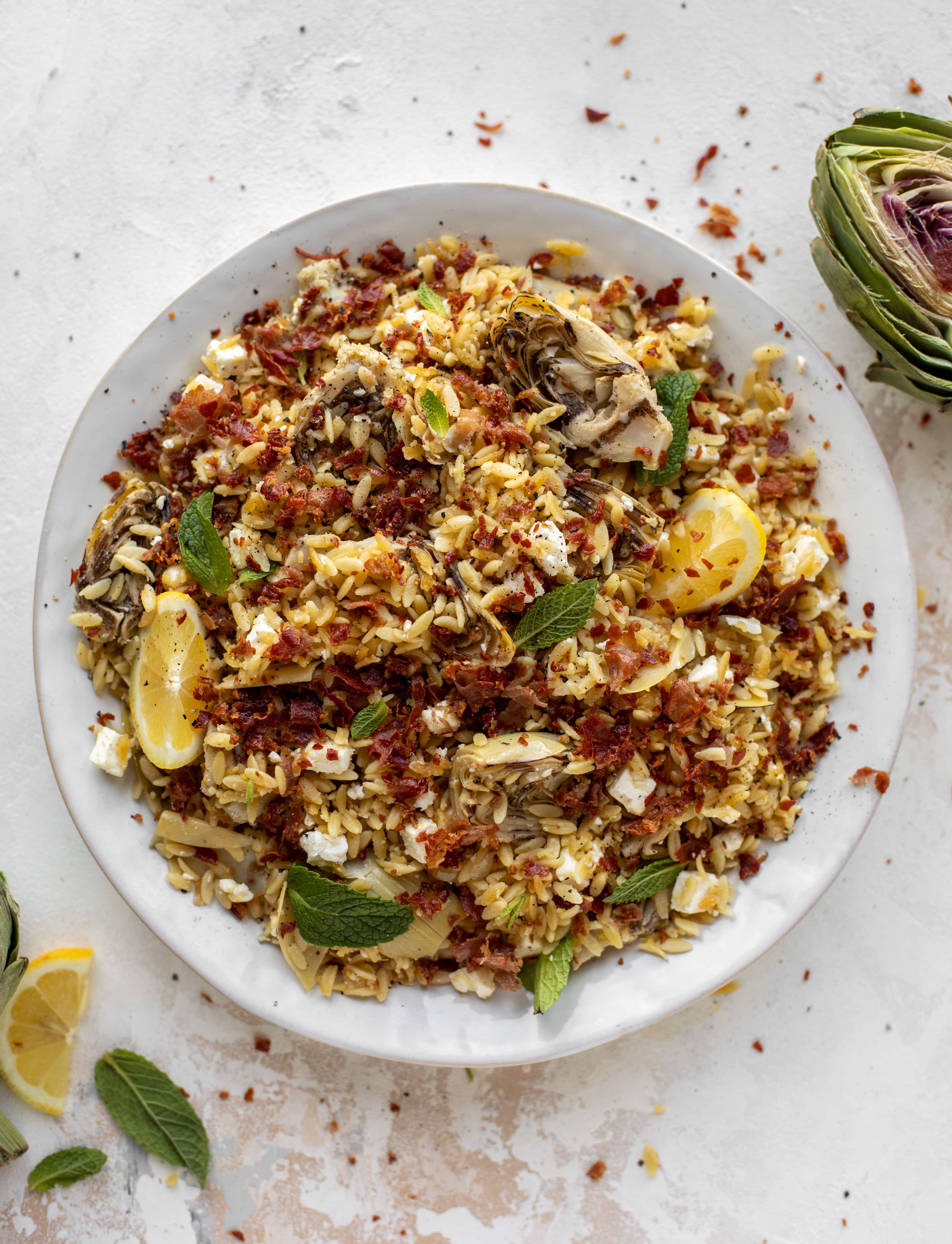 This crispy orzo is a wonderful spring dish. Artichoke hearts, lemon, goat cheese and herbs all topped with a sprinkling of crunchy prosciutto. 