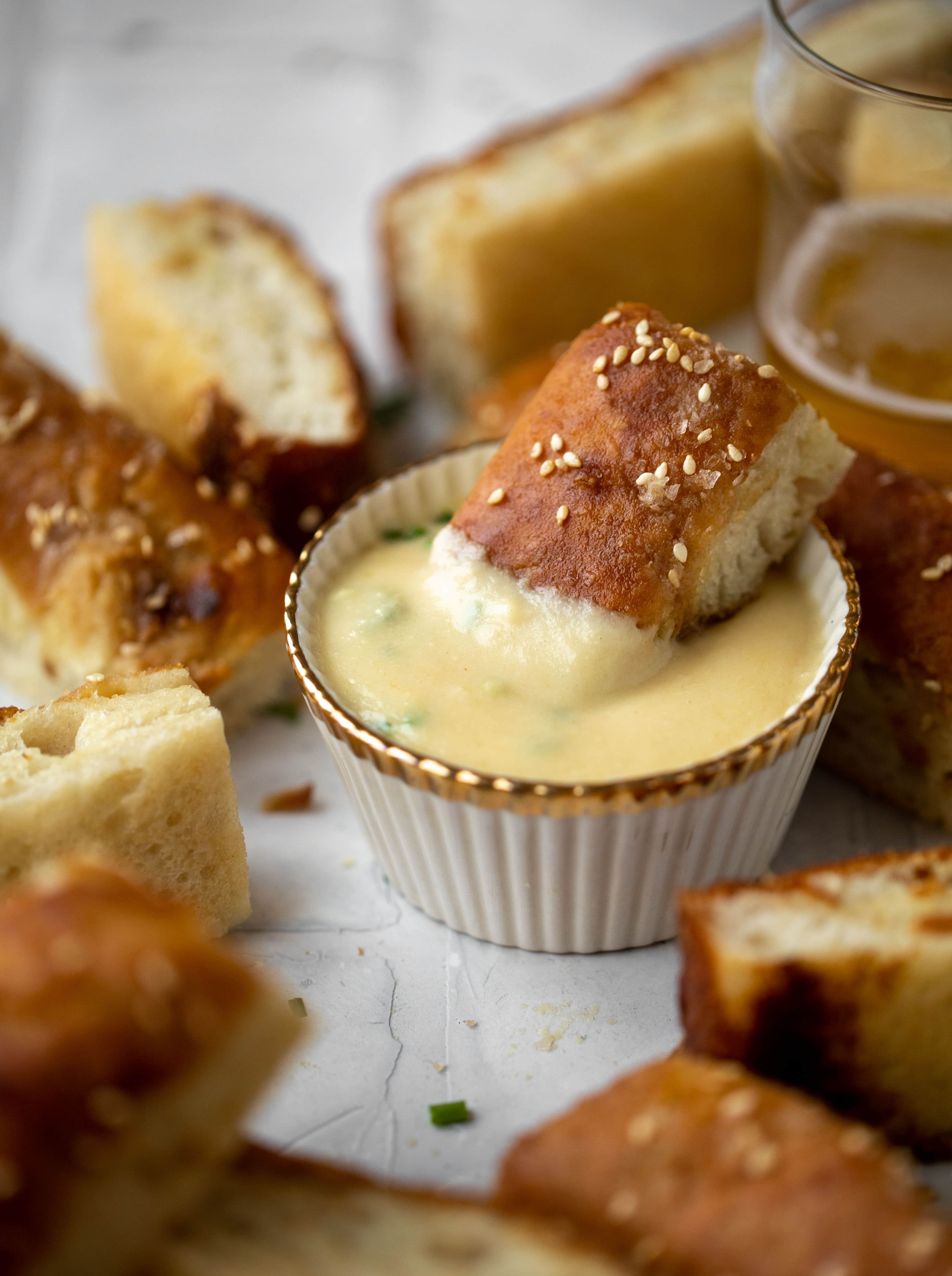 This sesame pretzel focaccia bread is amazing! Almost like a soft pretzel with crispy edges. Serve with a delicious dijon beer cheese.